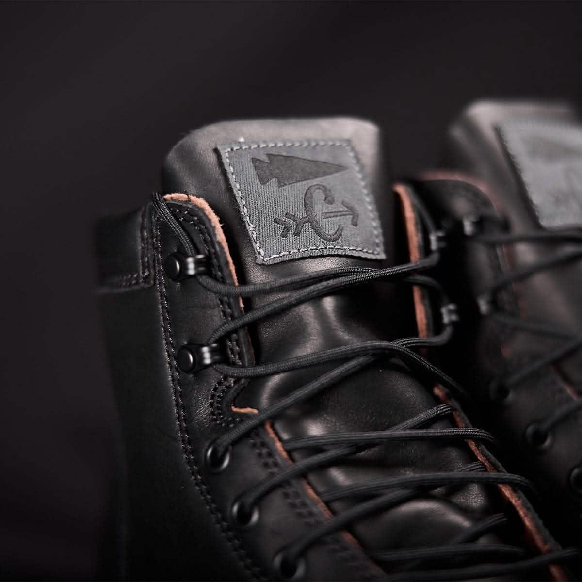 Close-up of black GORUCK rucking boots with logo patch and detailed laces