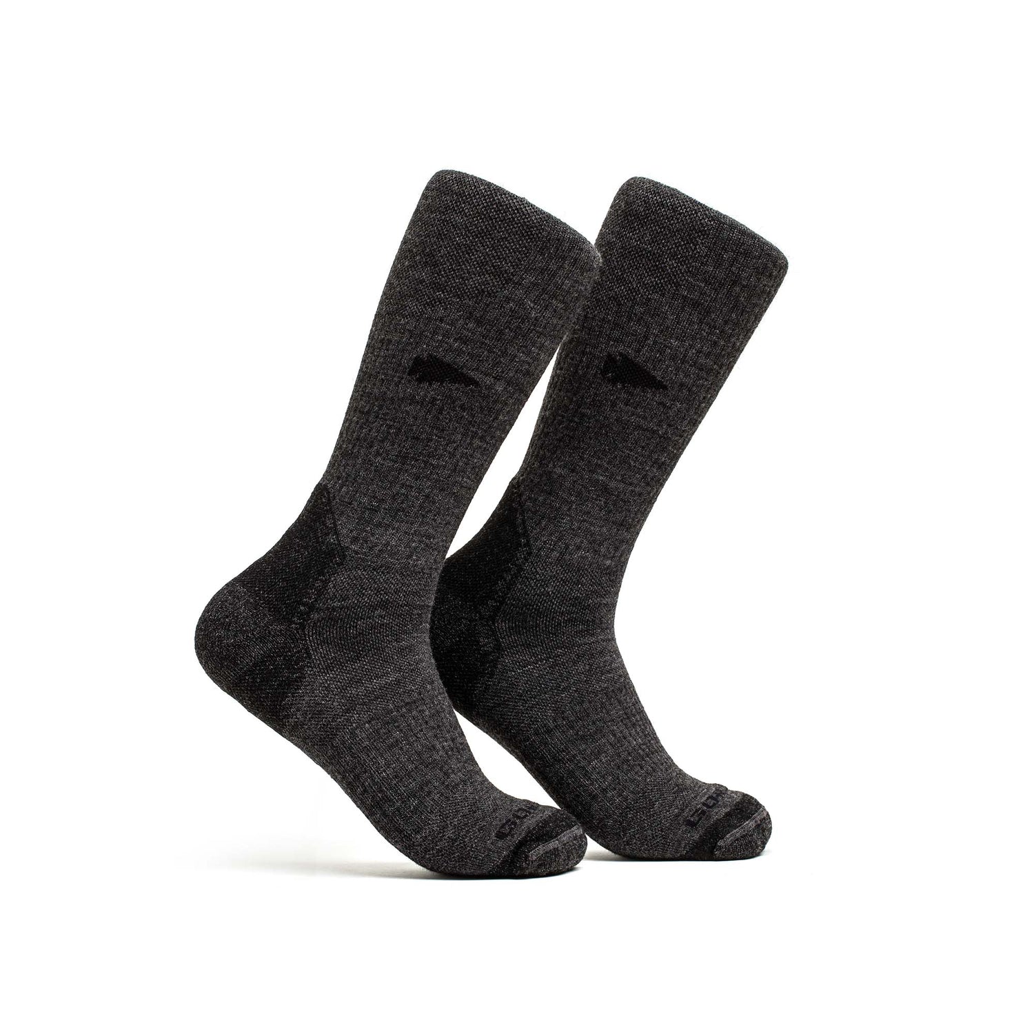 A pair of Merino Compression Socks in dark gray, featuring graduated compression, stand upright on a white background.