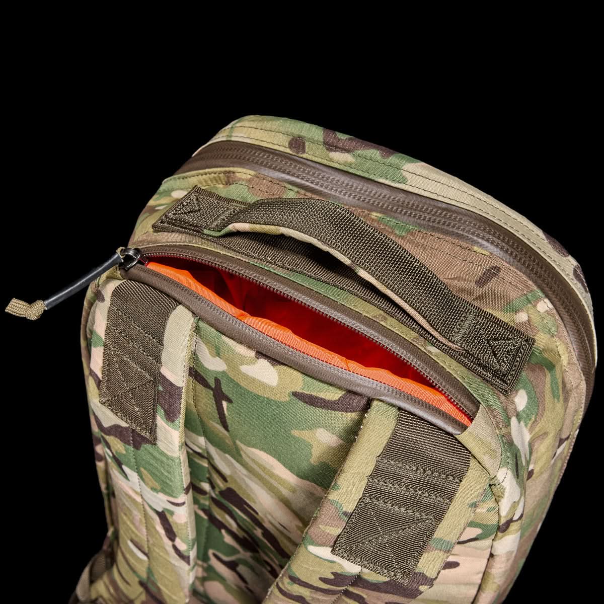 The Bullet X-PAC is a camouflage-patterned daypack featuring an open AquaGuard zipper that reveals a bright orange interior.