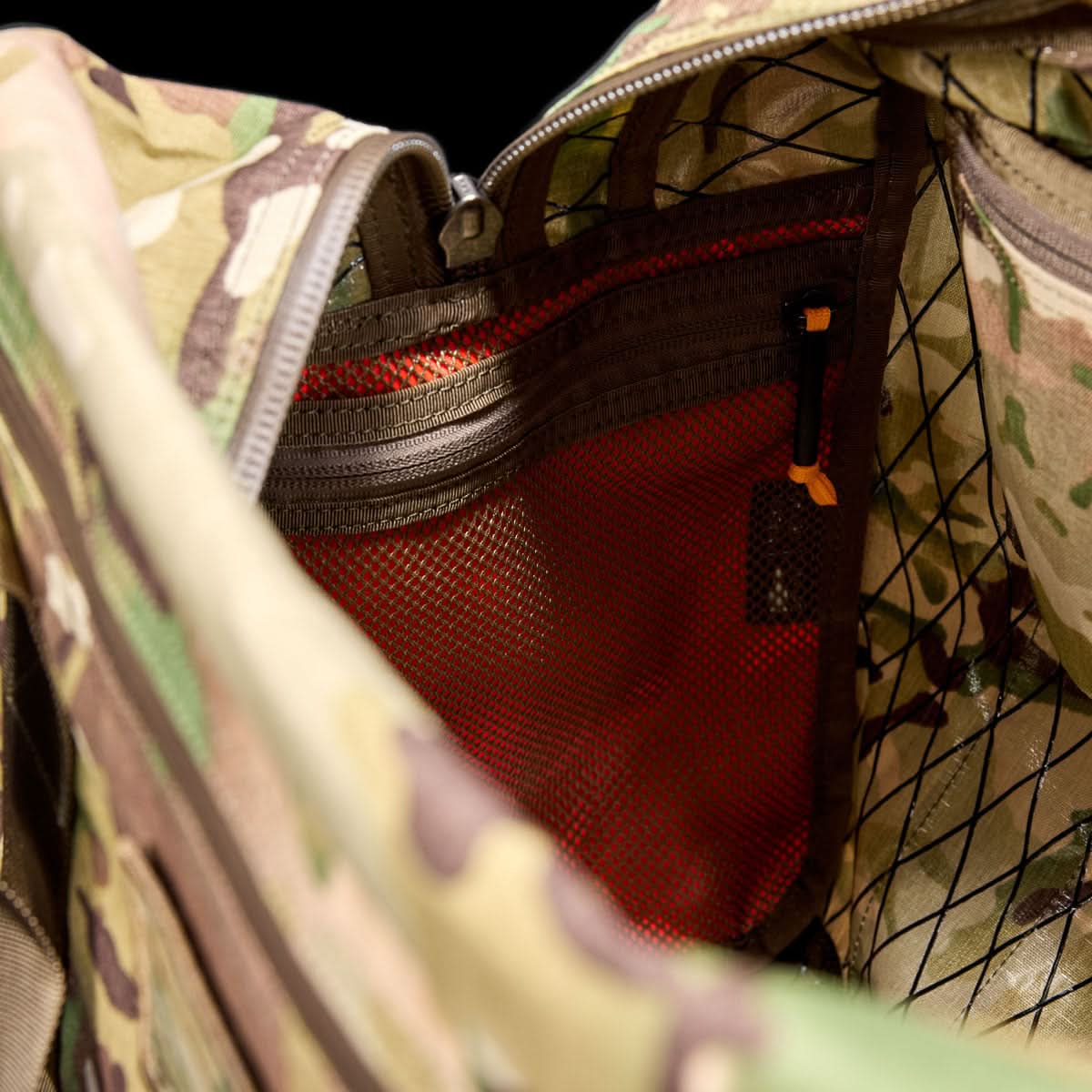 Close-up of the Kit Bag - X-PAC interior, made with X-PAC VX21 fabric, featuring mesh pockets, zippers, and bright orange lining inspired by Special Forces equipment.