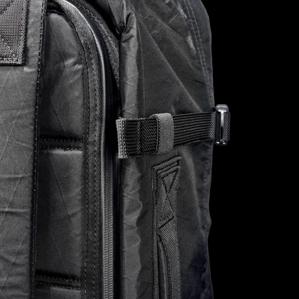 Close-up of black GORUCK 45L GR3 Xpac rucksack with durable fabric, zipper, and strap detail
