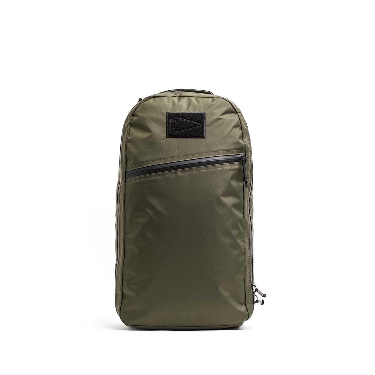 The Bullet X-PAC daypack in olive green features a diagonal front AquaGuard zipper pocket, displayed upright on a white background.