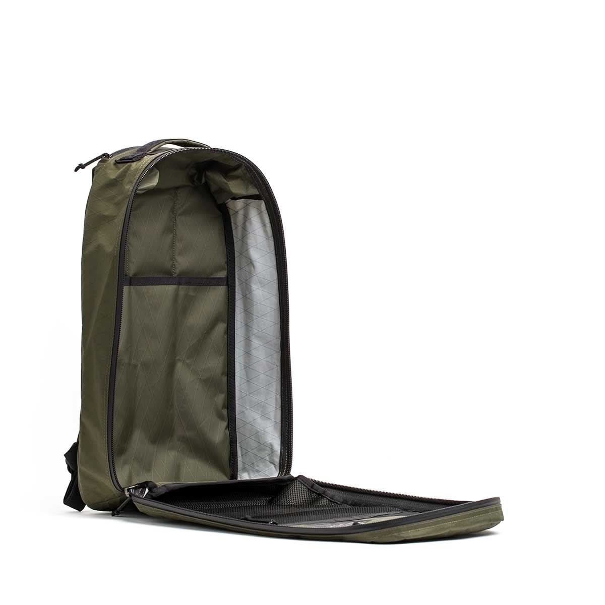 The Bullet X-PAC is an olive green daypack featuring a spacious main compartment, a mesh pocket inside the front flap, and AquaGuard zippers for added protection.