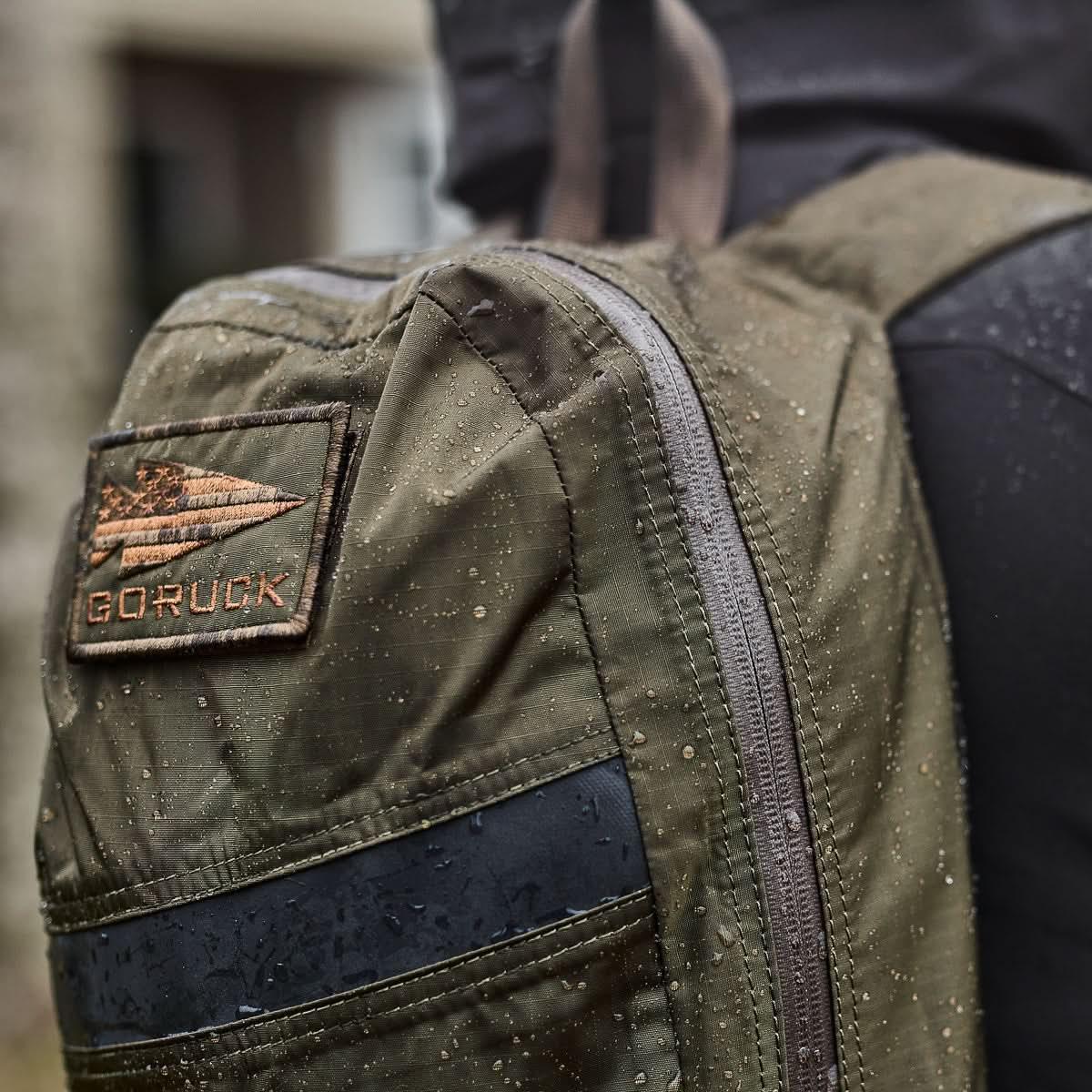 GORUCK waterproof backpack with logo patch and rain droplets outdoors