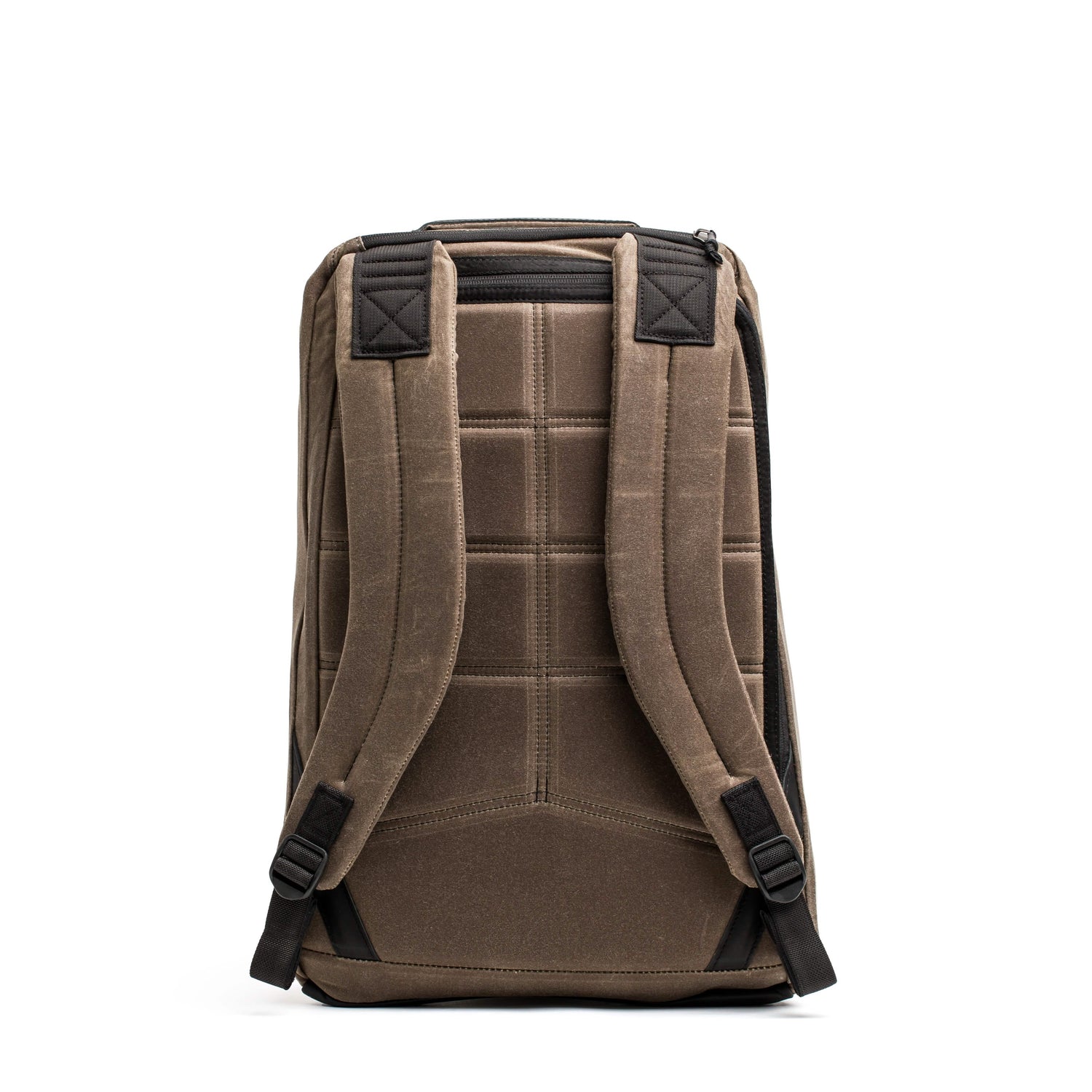 The GR1 USA - Heritage by GORUCK is displayed upright against a white background. This brown rucksack boasts padded straps and back support, featuring black accents and visible stitching on the waxed duck canvas for a sturdy and ergonomic look.