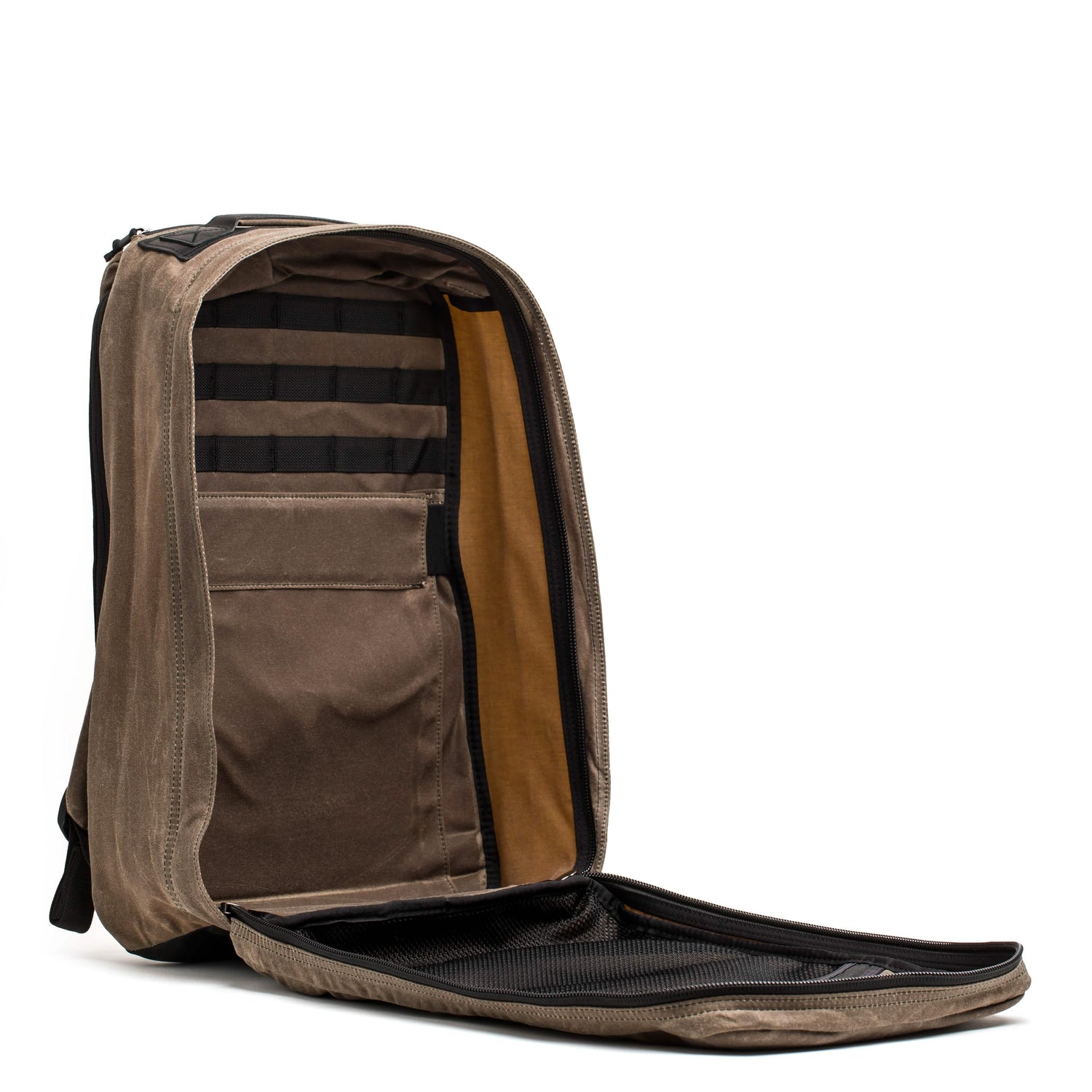 Open Heritage Dark Oak rucksack by GORUCK showing spacious interior with organizer pockets and padded laptop sleeve