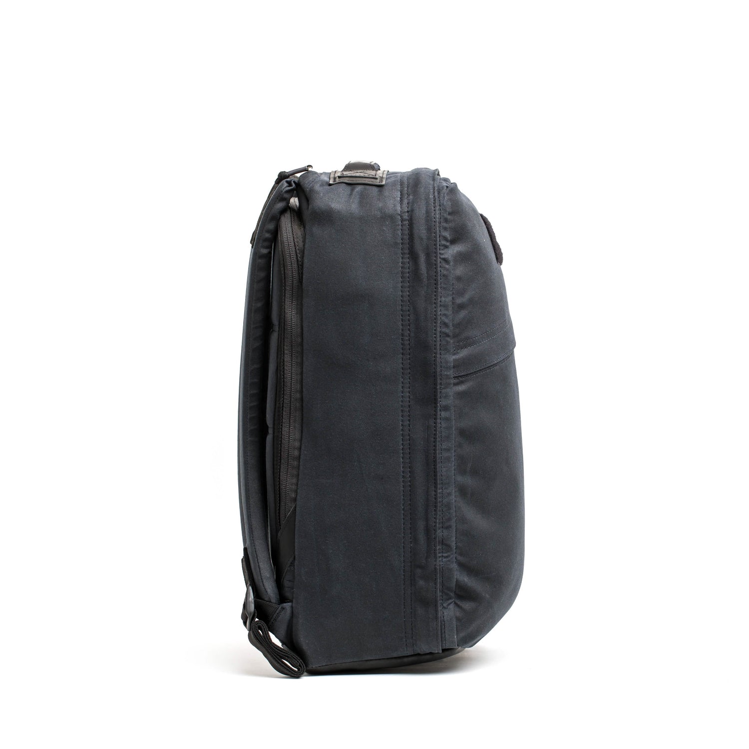 Side view of the GORUCK GR1 USA - Heritage, a black rectangular laptop bag featuring a shoulder strap and zipper pockets. This sleek and compact retro canvas rucksack is designed for convenient portability and storage of electronic devices.