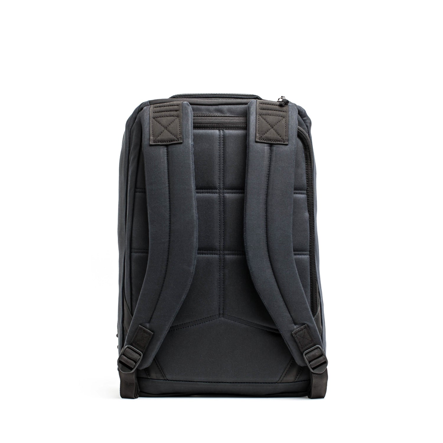 The GORUCK GR1 USA - Heritage in black is displayed from the back, showcasing its padded shoulder straps and stitched design on the back panel for enhanced comfort and support. The top features a zipper opening, merging classic style with modern functionality.
