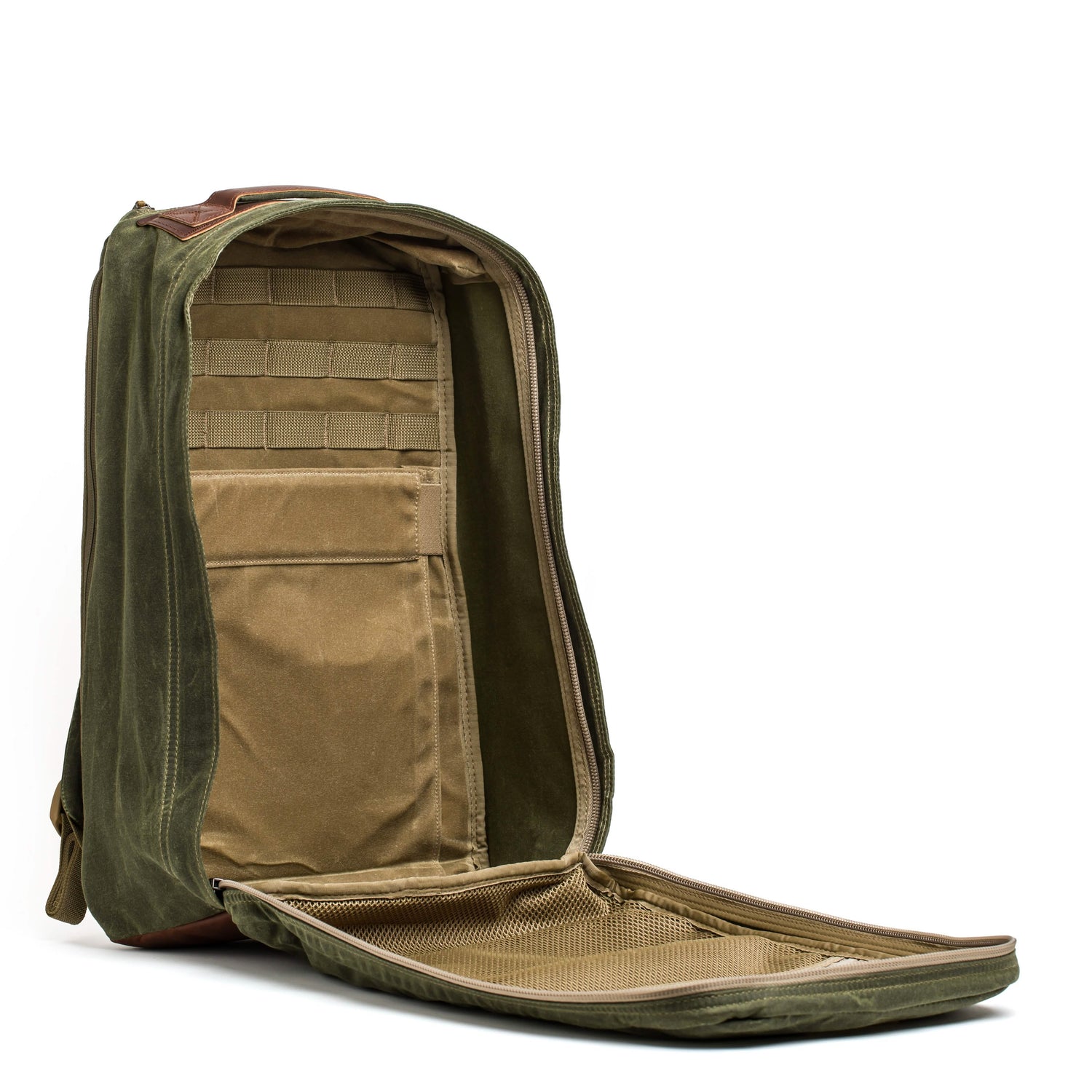 The GR1 USA - Heritage backpack by GORUCK, in an open olive green with a tan interior, boasts several compartments including a mesh pocket located in the front flap. Made from sturdy waxed duck canvas, this backpack is showcased against a white background for a stylish yet robust appearance.