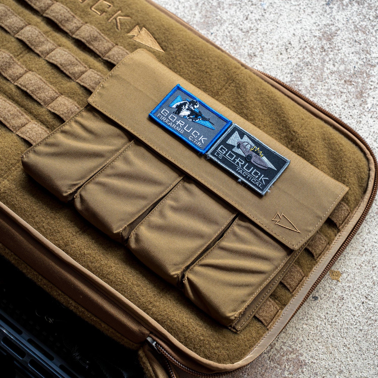 A brown Rifle Case with patches reading