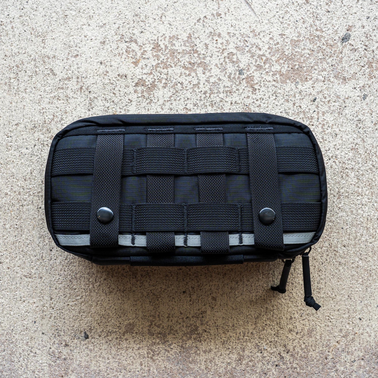 IFAK (Black + Red Thread + Grey Interior + Red Patch) ROBIC w/ Aquaguard, featuring webbing and snap buttons, displayed on a textured beige surface.