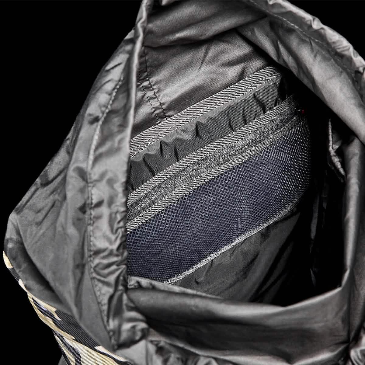 Interior view of GORUCK rucksack featuring durable black nylon lining and mesh pocket for organized storage