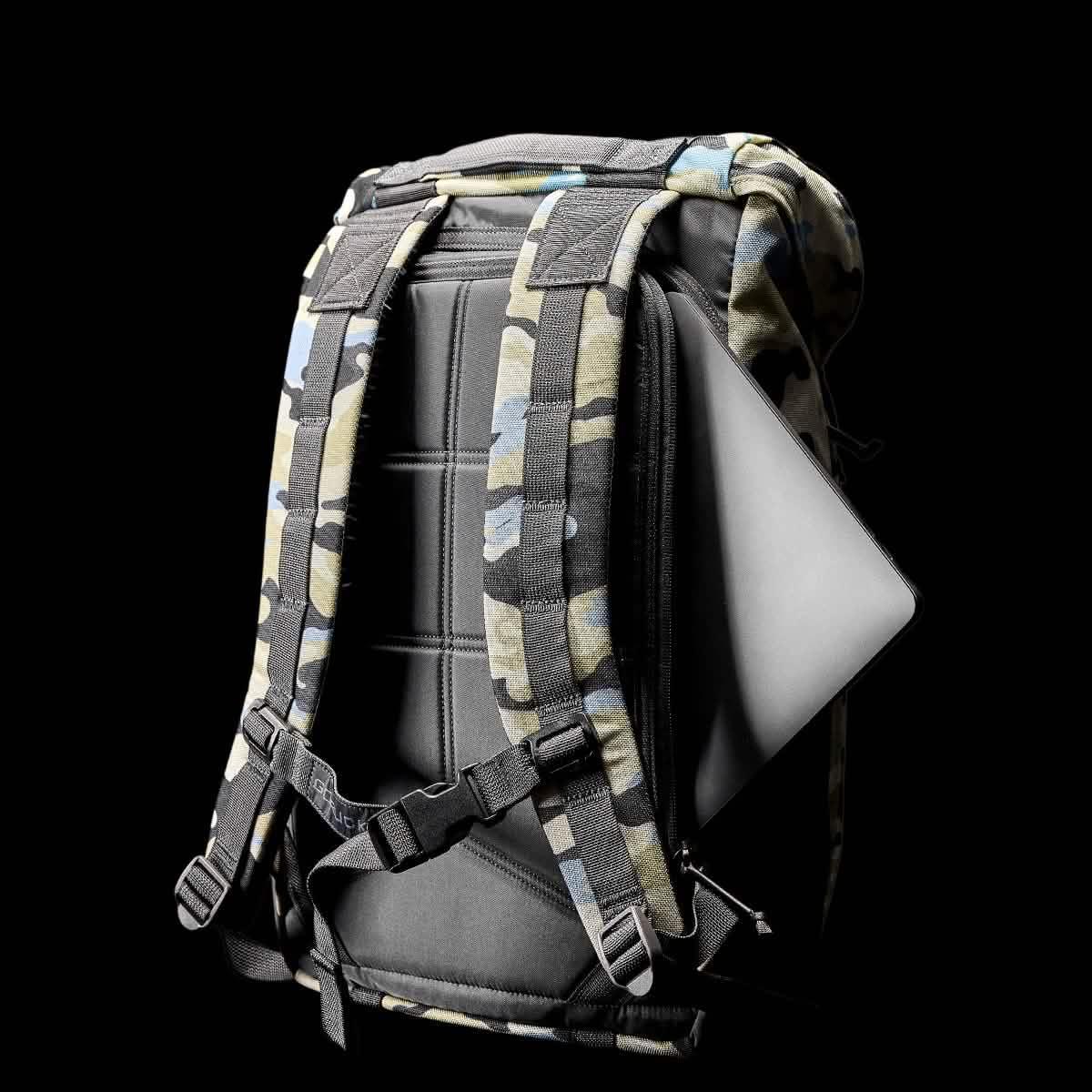 Everglades camo GORUCK backpack with padded back panel and shoulder straps holding a laptop