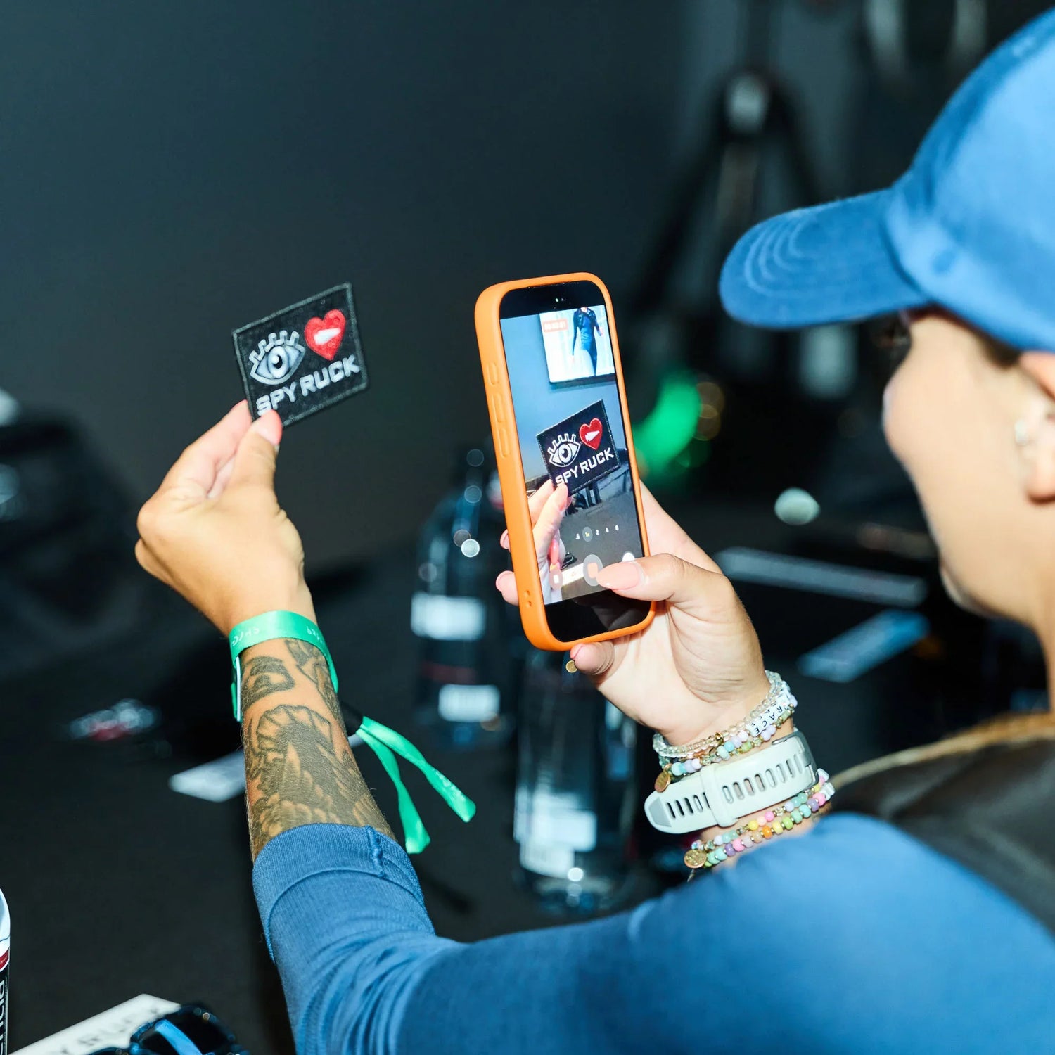 GORUCK event attendee photographing Spy Ruck patch with smartphone