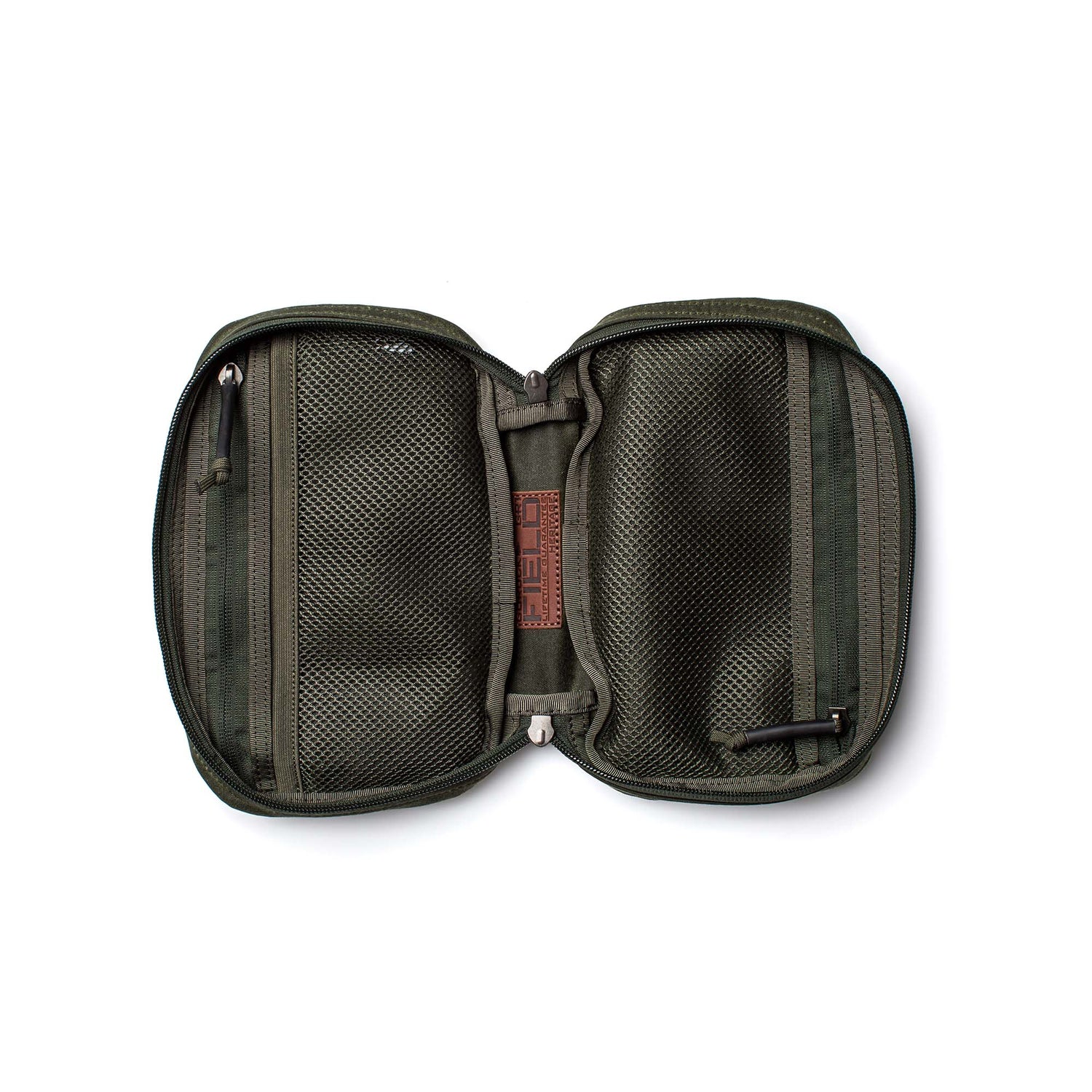 The GR1 Field Pocket - Waxed Canvas is shown open from above on a white background, featuring green waxed canvas, mesh pockets, and a pen.