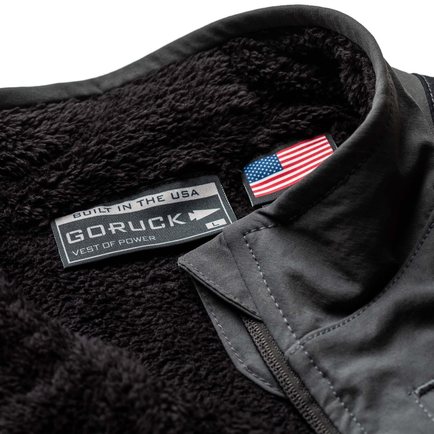 Close-up of black GORUCK fleece vest interior showing soft texture and USA flag label