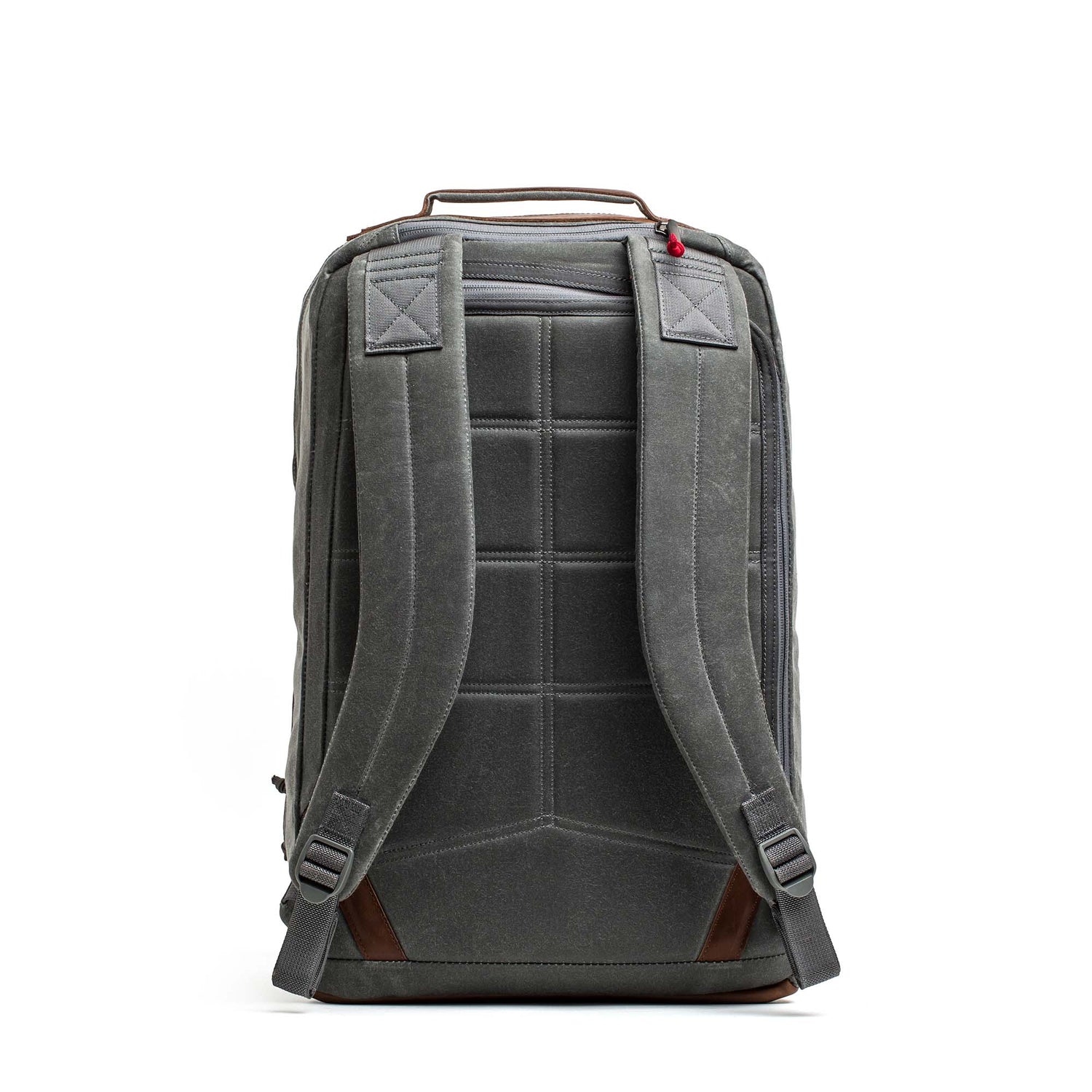 The GR2 - Heritage Waxed Canvas backpack is shown from the back, featuring padded straps, Red Wing Leather brown accents, and a durable travel ruck design, standing on a white background.