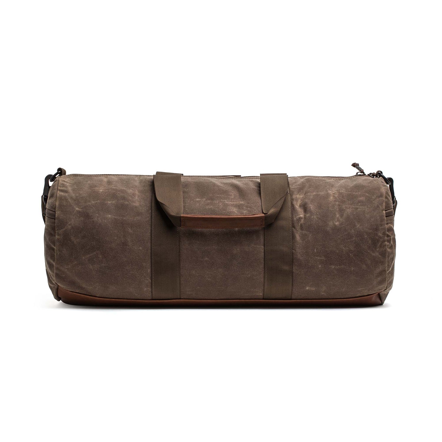 The Gym Bag - Waxed Canvas is shown in brown with handles and a shoulder strap, viewed from the front on a white background.