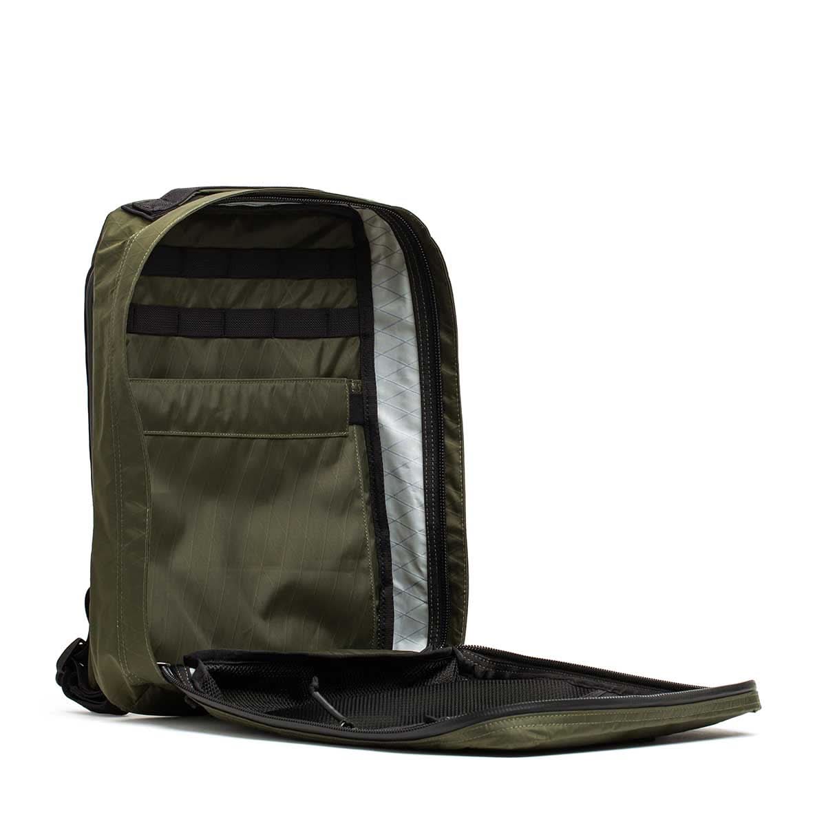 The GR0 - X-PAC is an olive green lightweight rucksack with a clamshell opening, made from waterproof material and featuring organized interior compartments.