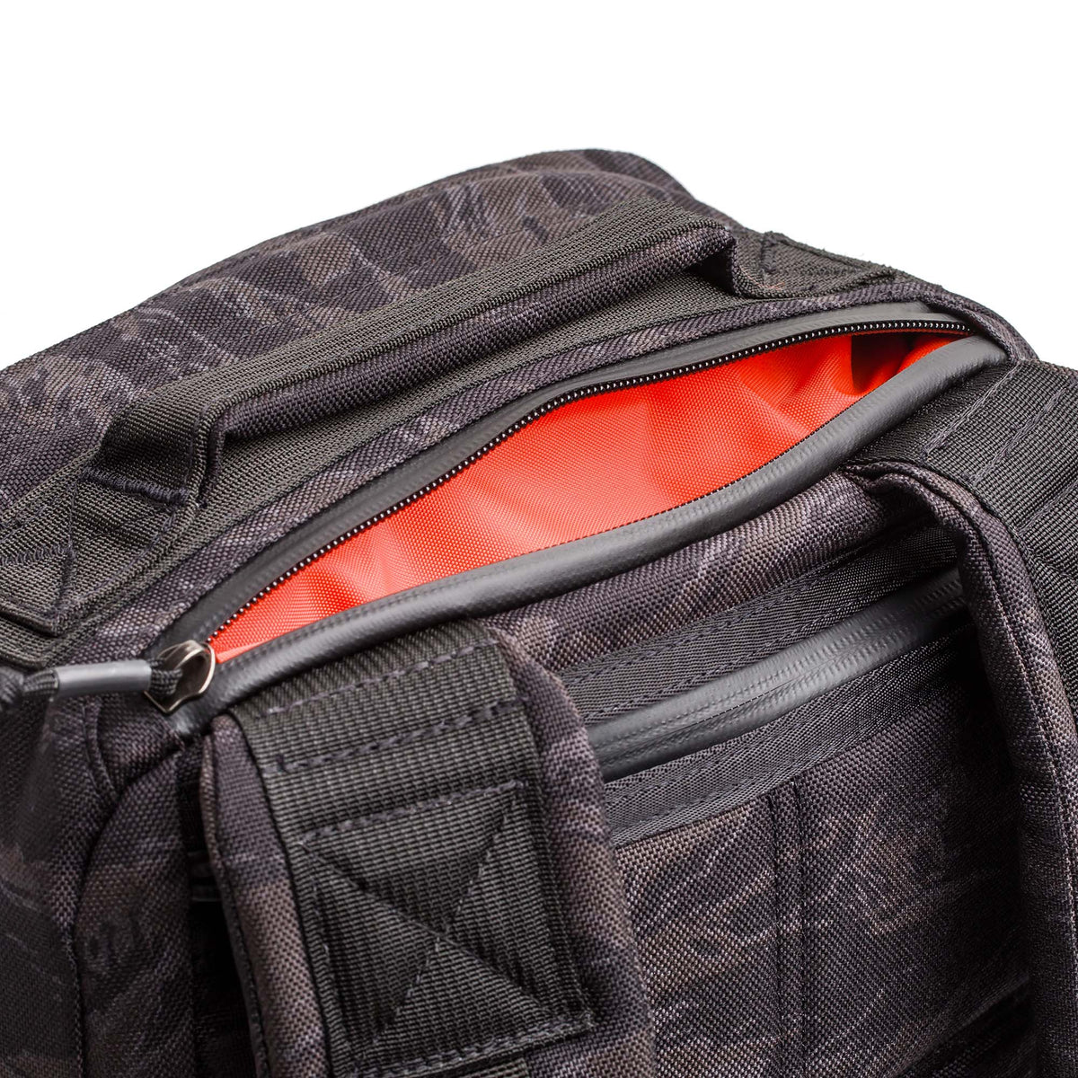 Close-up of the GR1 USA - Cordura, an everyday carry rucksack in black with an open zipper, revealing a bright orange lining—engineered for Special Forces-grade durability.