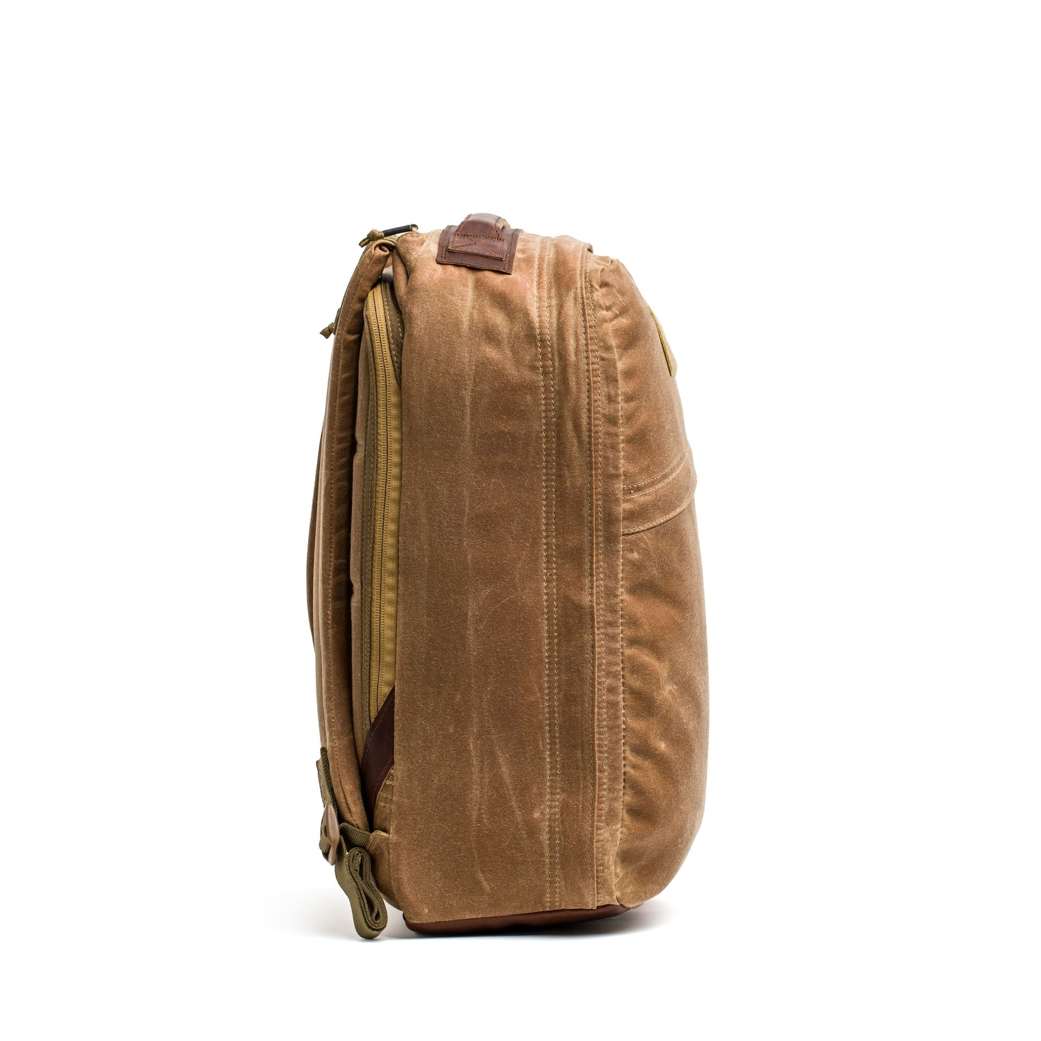 Side view of the GR1 USA - Heritage rucksack by GORUCK, made from brown waxed duck canvas, featuring a zipper and durable straps.