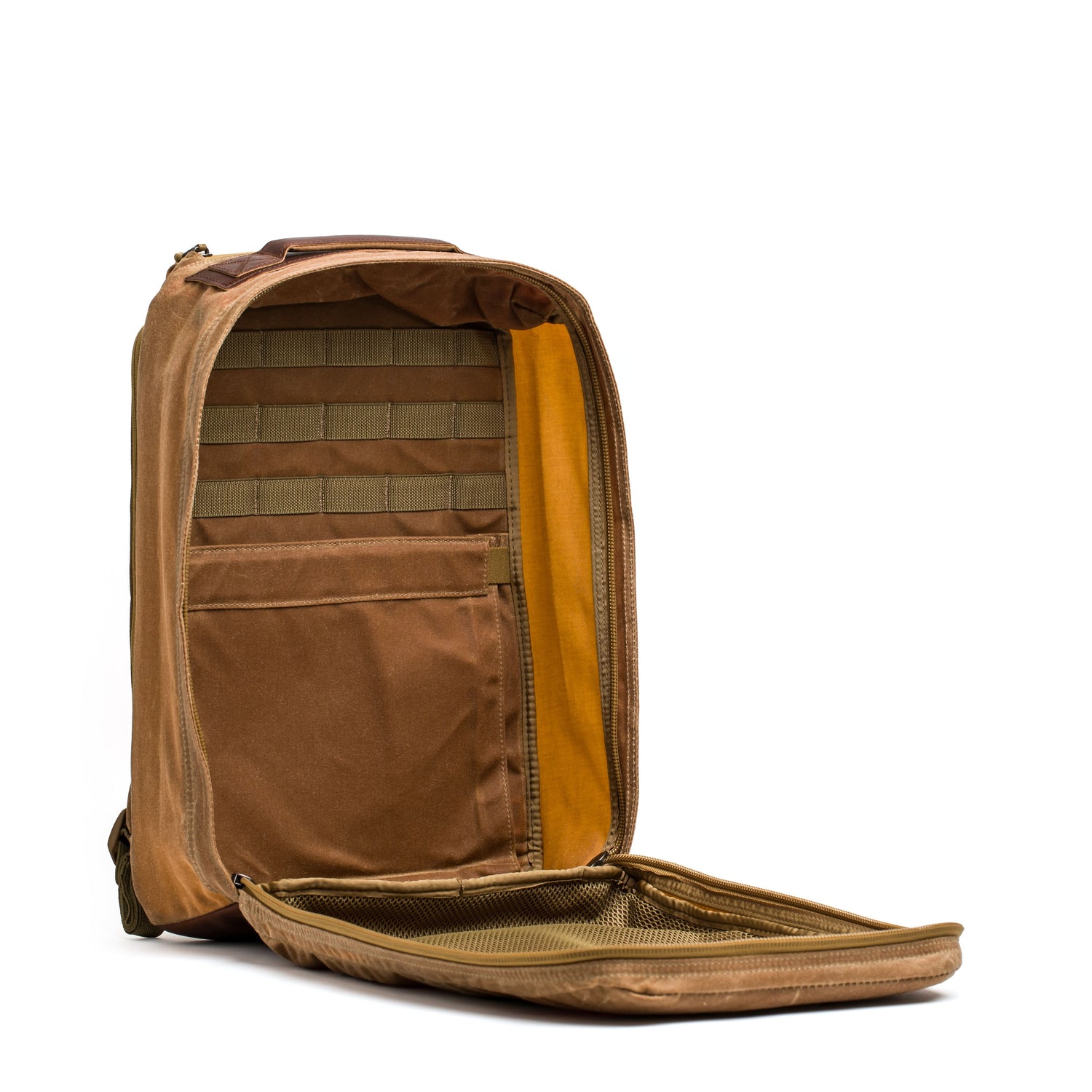 The GR1 USA - Heritage from GORUCK is a rucksack designed with waxed duck canvas, showcasing a brown open backpack style with various compartments and pockets, set against a white background.