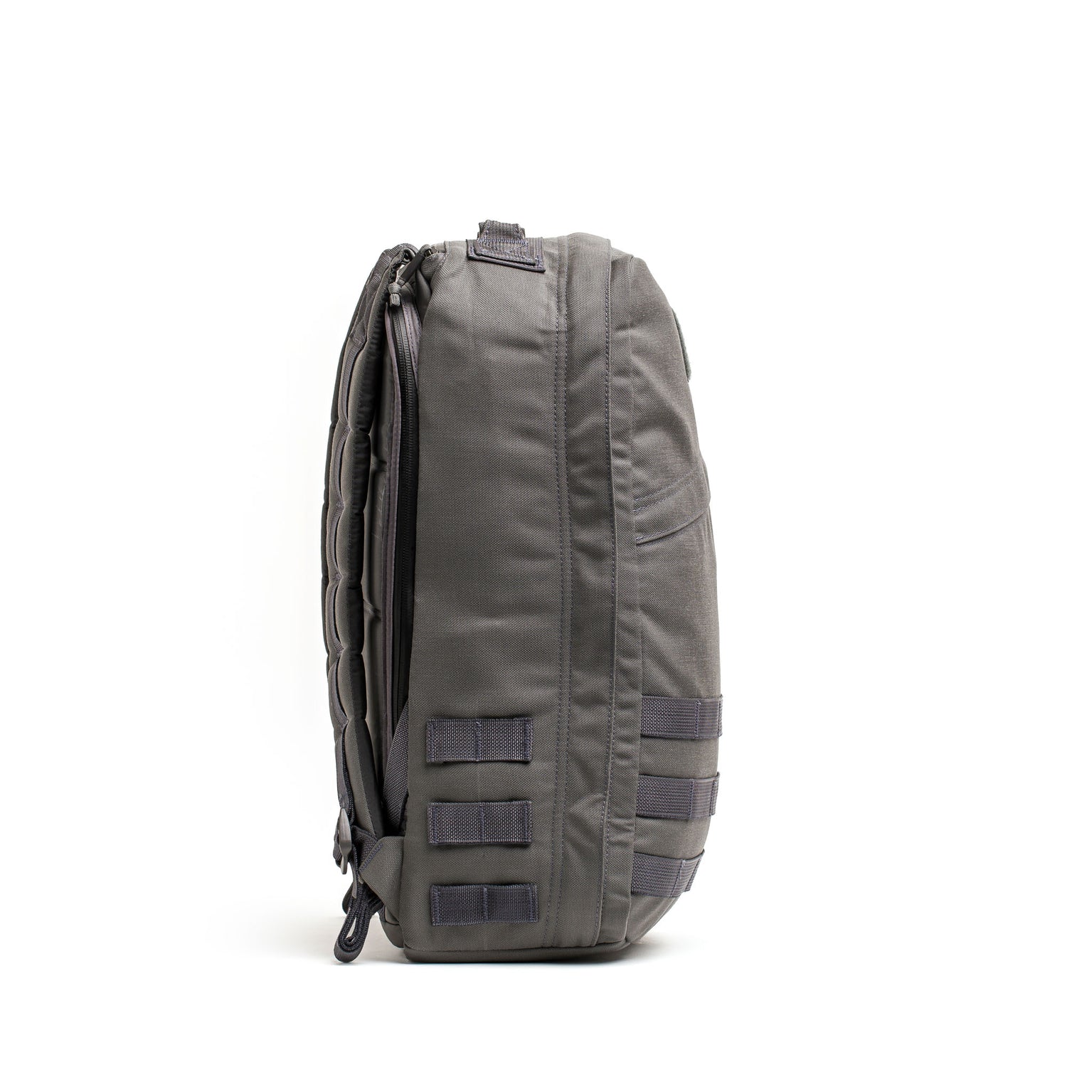 A gray GR1 USA - Cordura rucksack, Special Forces tested, stands upright on a white background, shown from the side—ideal for everyday carry.