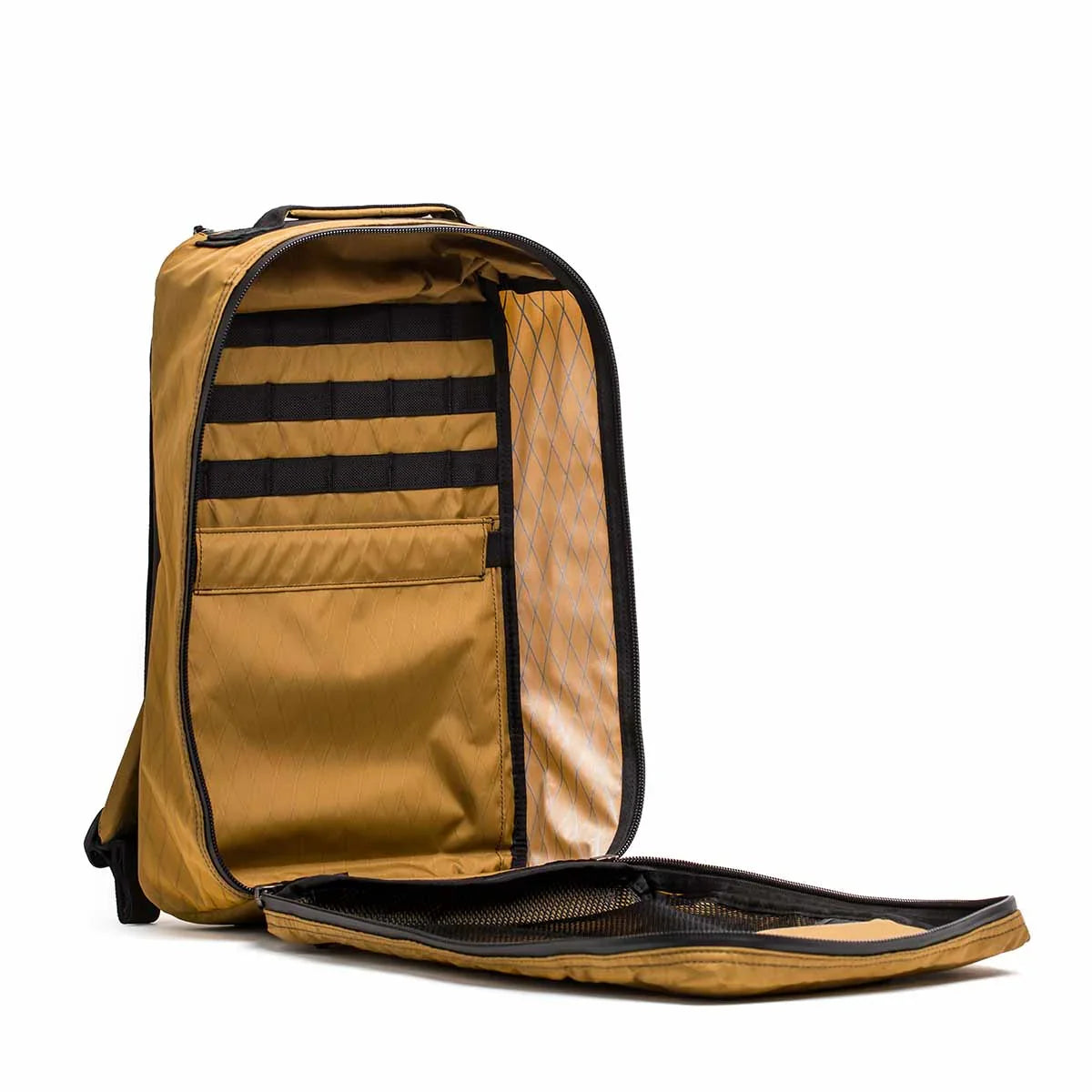 Open coyote color GORUCK rucksack showing interior organization with zippered compartments and MOLLE webbing