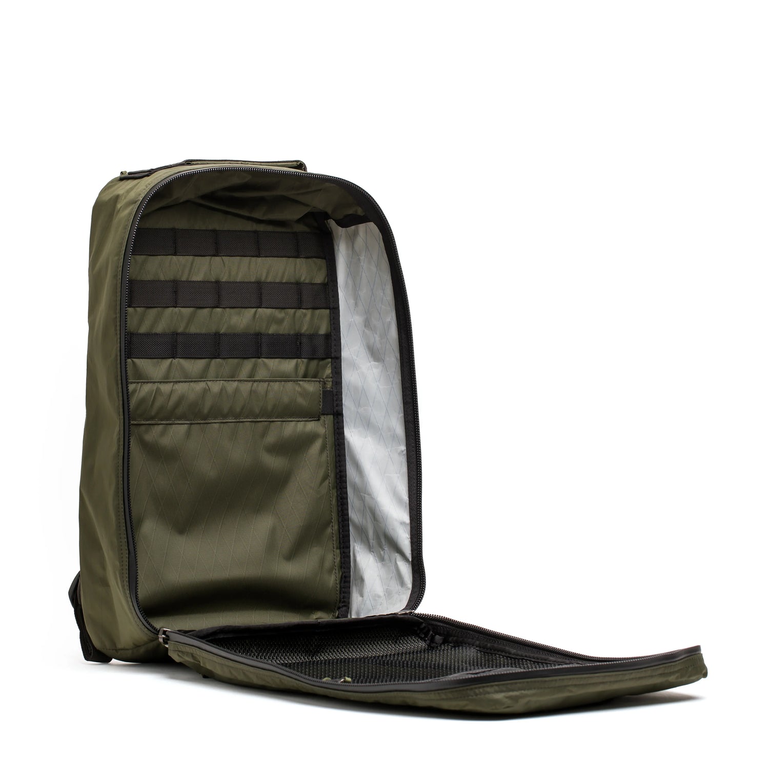 Open dark green GORUCK backpack showing organized interior with black webbing and mesh pocket