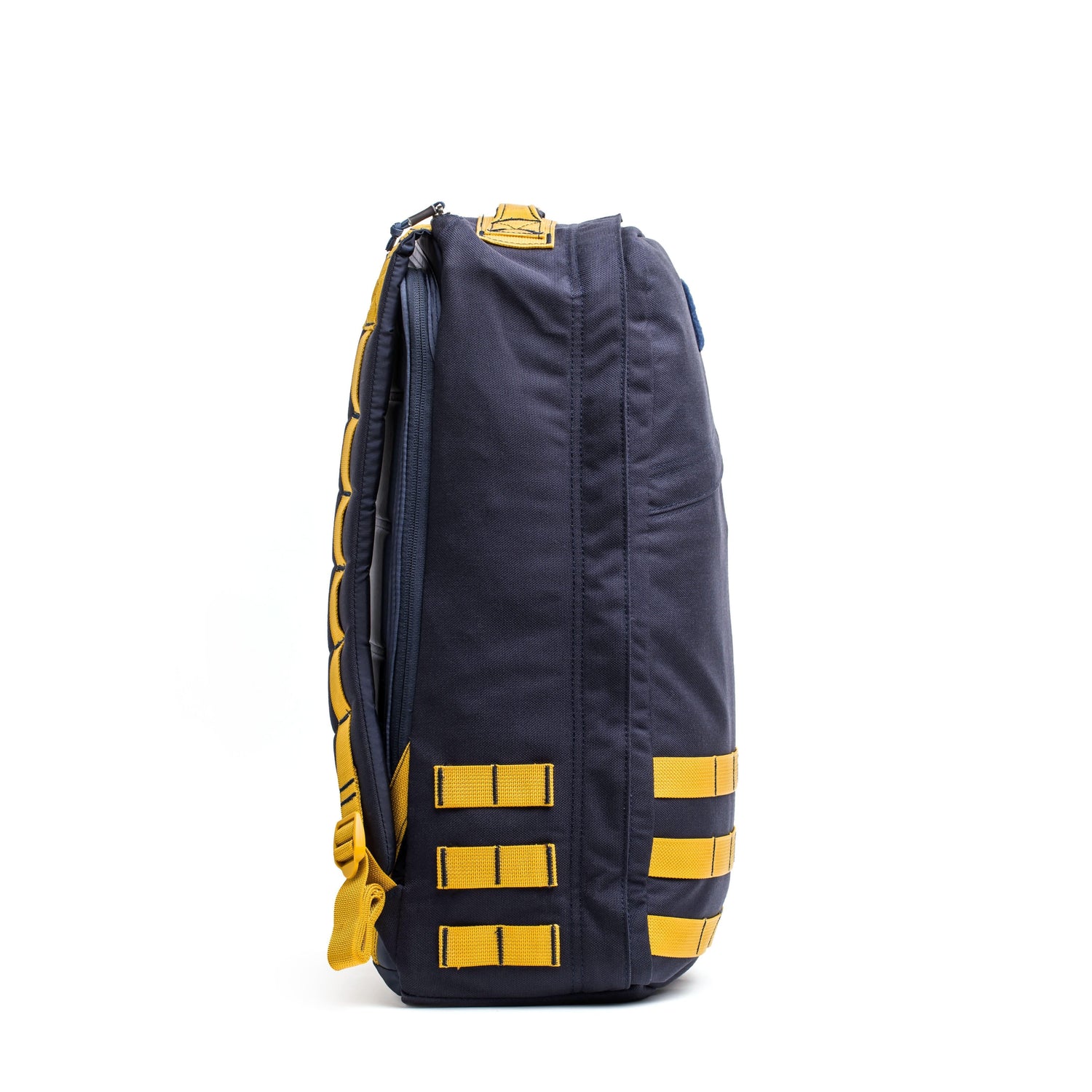 Side view of navy and light gold GORUCK rucksack with durable stitching and attachment loops