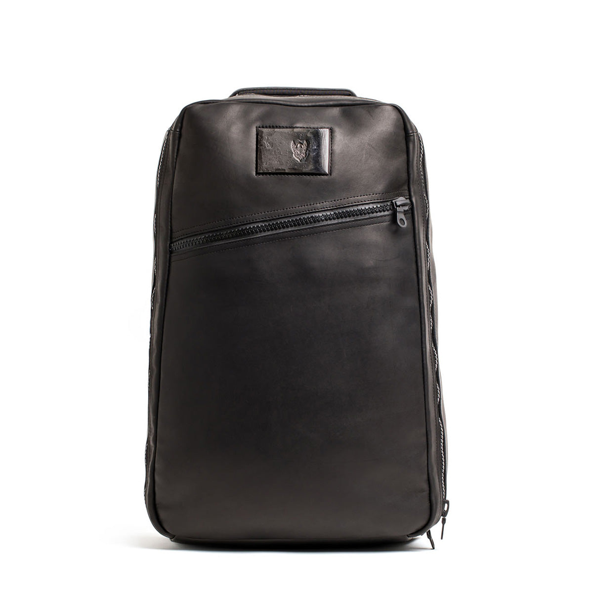 The GR1 USA x Carryology - Berserker Viking is a sleek black leather backpack featuring a diagonal front zipper and a small rectangular patch near the top, inspired by the bold spirit of Viking warriors.