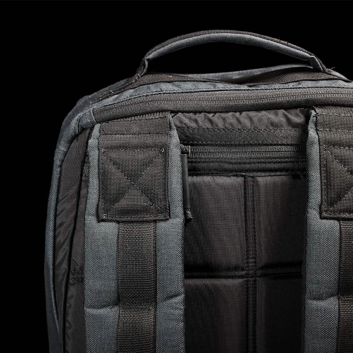 Close-up image of the GORUCK GR1 USA - Cordura (The Original Ruck) backpack in black, designed for the GORUCK Challenge. It features sturdy top handles and padded shoulder straps against a black background, with durable and textured fabric reminiscent of Special Forces gear.