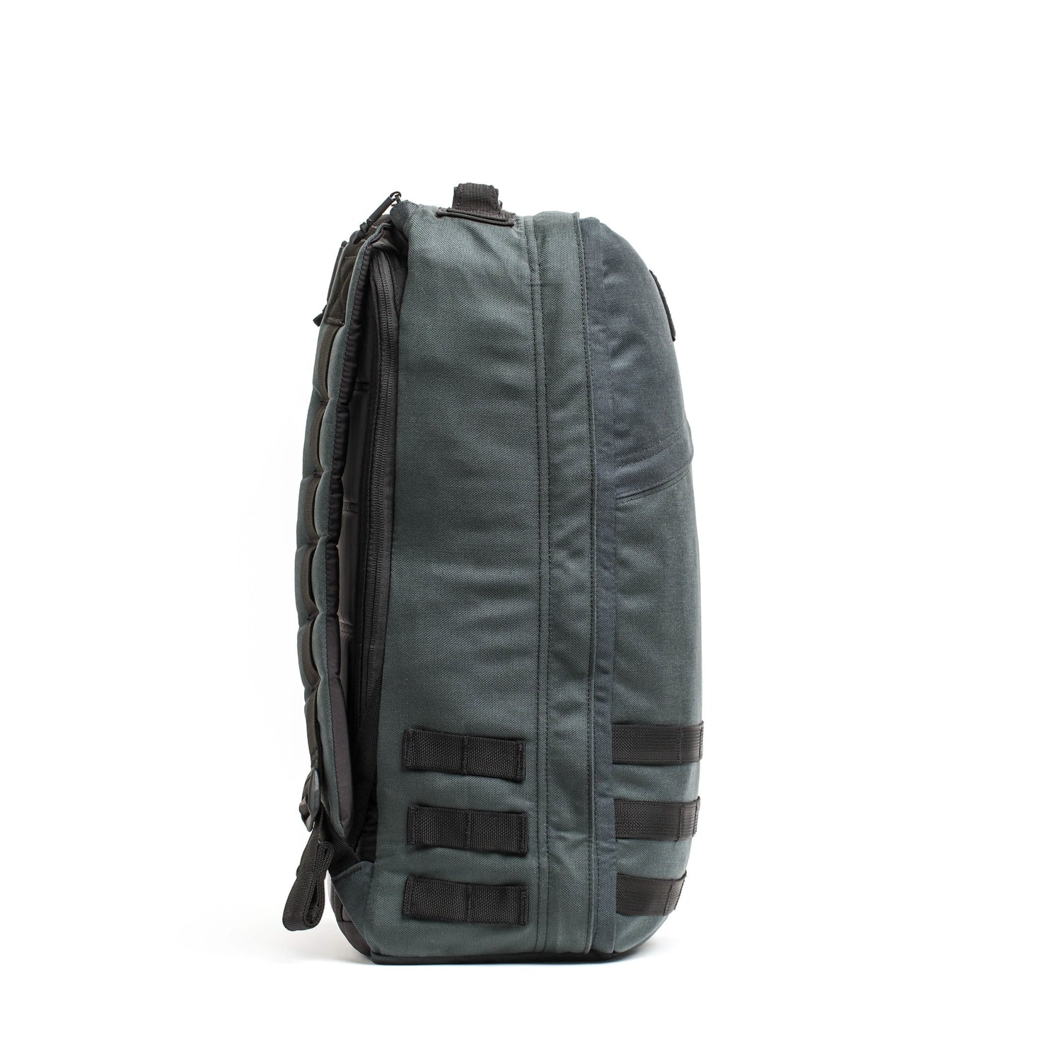 Here is a rewritten version of the sentence using the product data:
Side view of a dark gray GORUCK GR1 USA - Cordura backpack with padded straps, inspired by Special Forces requirements. It includes multiple compartments and black attachment loops on the side, standing upright against a plain white background.