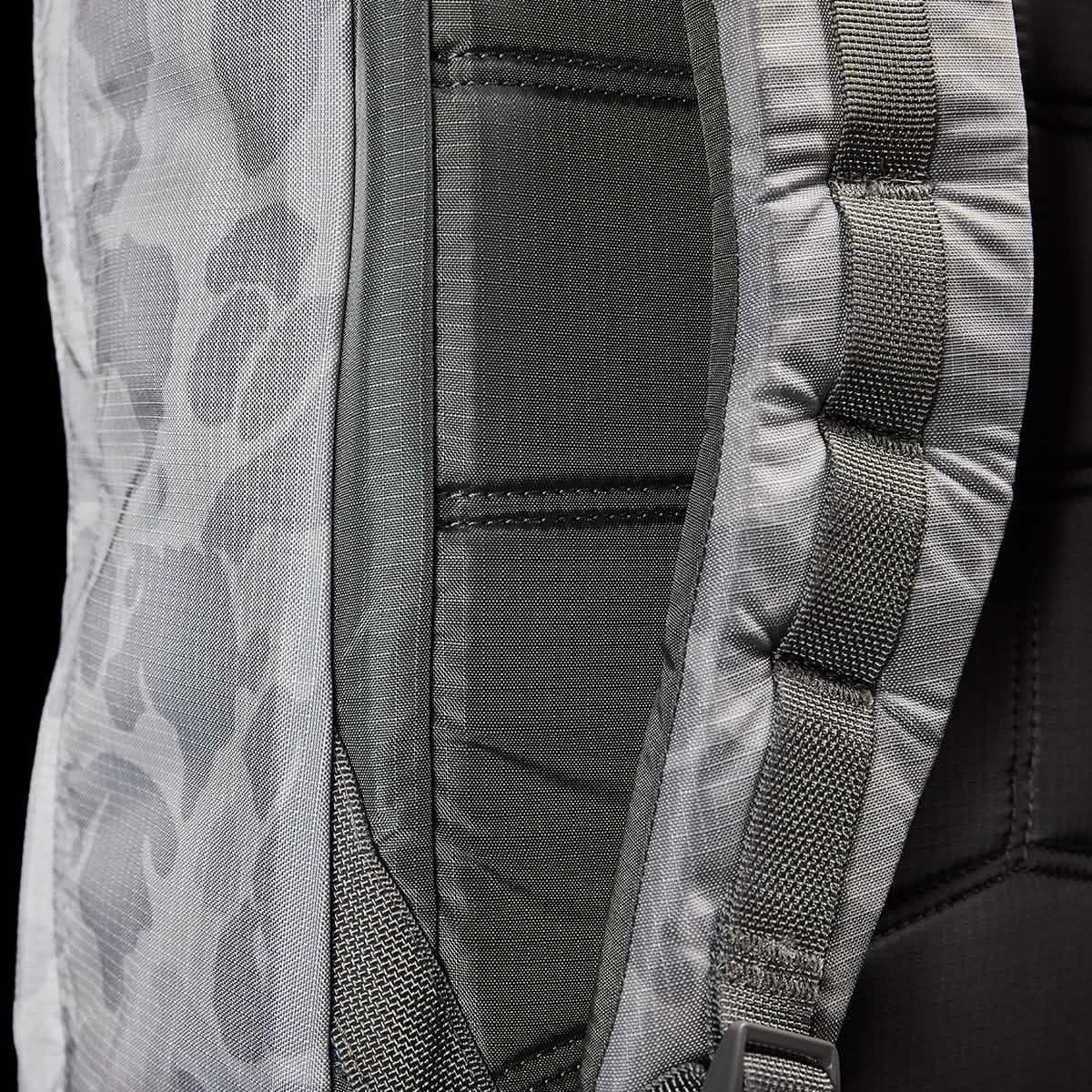 Close-up of gray Arctic Camo GORUCK backpack strap with durable stitched webbing and padded back