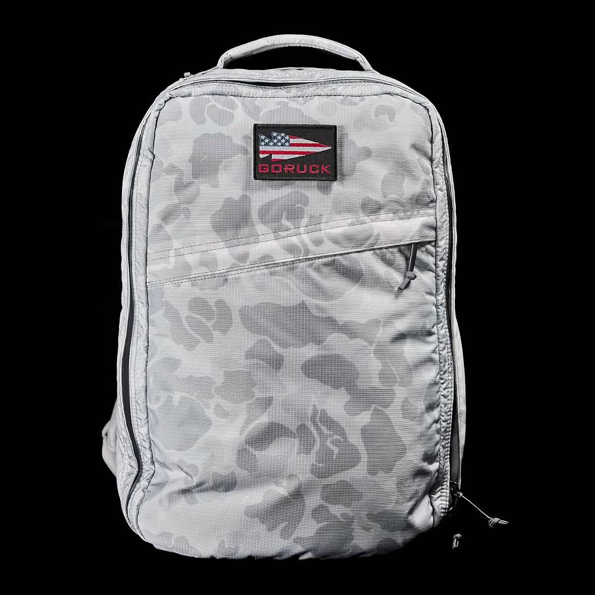 GORUCK Arctic camo backpack with American flag patch on front pocket against black background