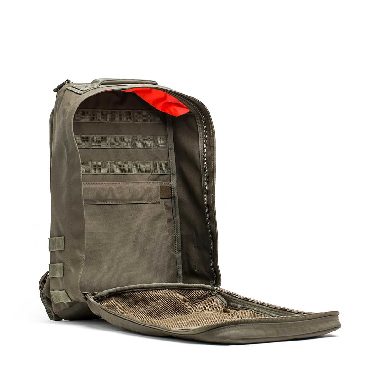 The olive green GR1 USA - Ballistic Nylon Cordura (The Original Ruck) backpack with 210D back panel is upright, showing internal compartments and mesh pocket, ideal for everyday carry, displayed on a white background.