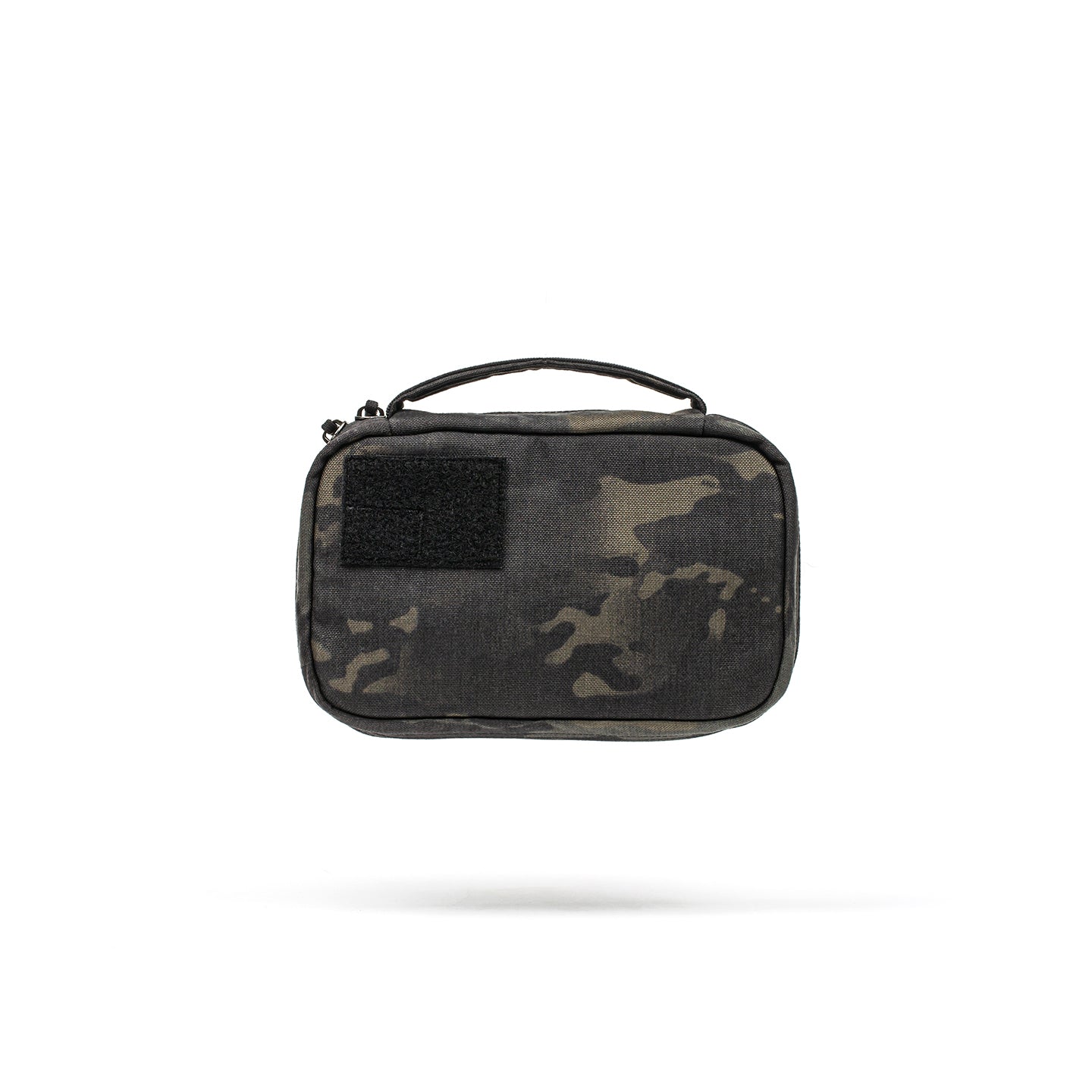 The GR1 Field Pocket is a compact camo-patterned zippered pouch with a handle and black patch, ideal for organizing electronics or carrying camera gear.