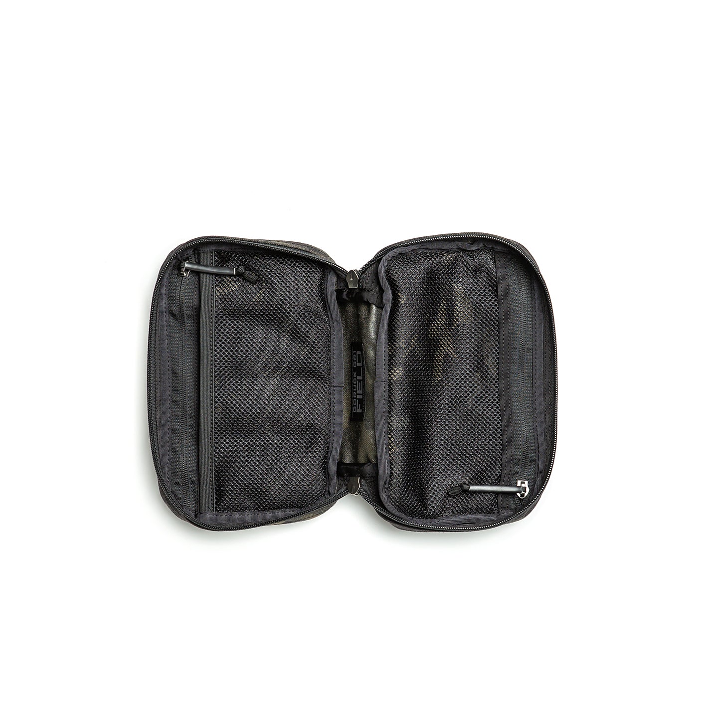 The GR1 Field Pocket, unzipped and lying flat on a white surface, reveals mesh compartments and pockets—ideal as an electronics organizer or for neatly storing camera gear while traveling.