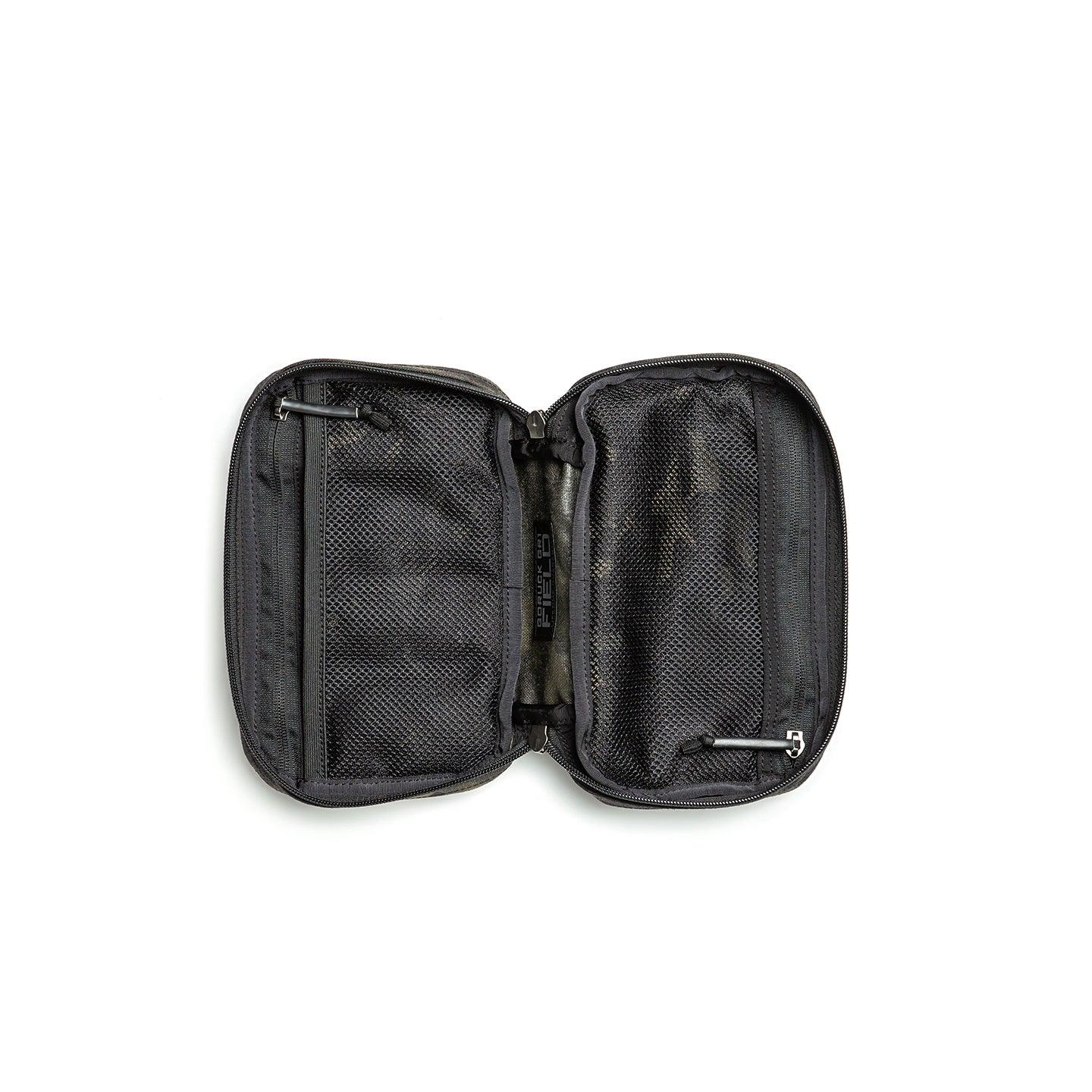 Open black GORUCK ruck field pocket with multiple mesh zippered compartments on white background