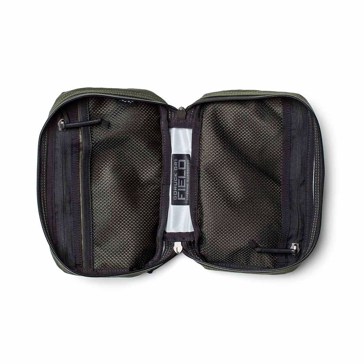 The GR1 Field Pocket - X-PAC is an open black mesh travel pouch made with waterproof X-PAC fabric, two AquaGuard zippered compartments, and a clear plastic center strip—ideal for organizing electronics.