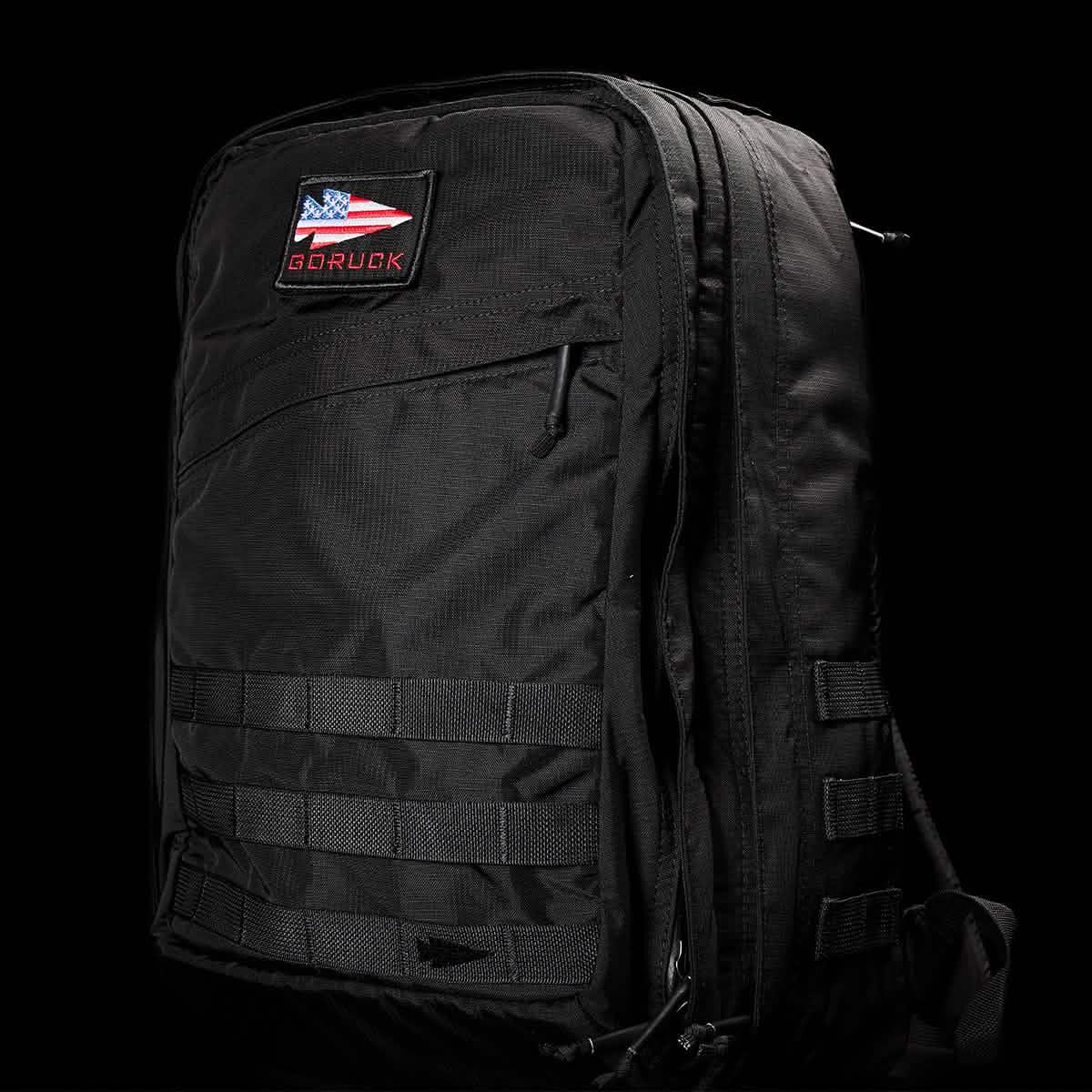 GORUCK black tactical backpack with American flag patch and MOLLE webbing on black background