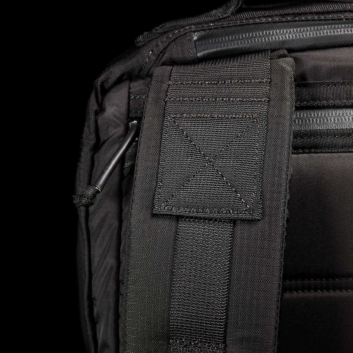 Close-up of durable black GORUCK rucksack strap and stitching, rugged rucking gear