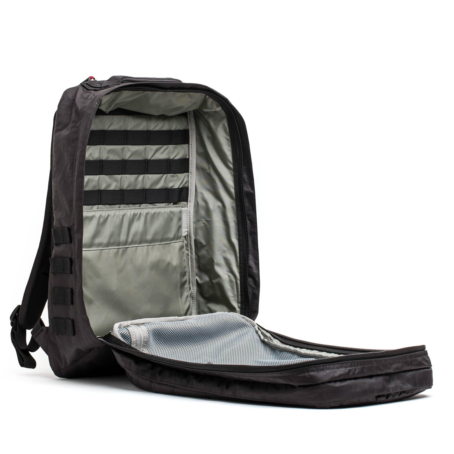 Black GORUCK backpack open showing organized interior with grey lining, mesh pocket, and webbing straps