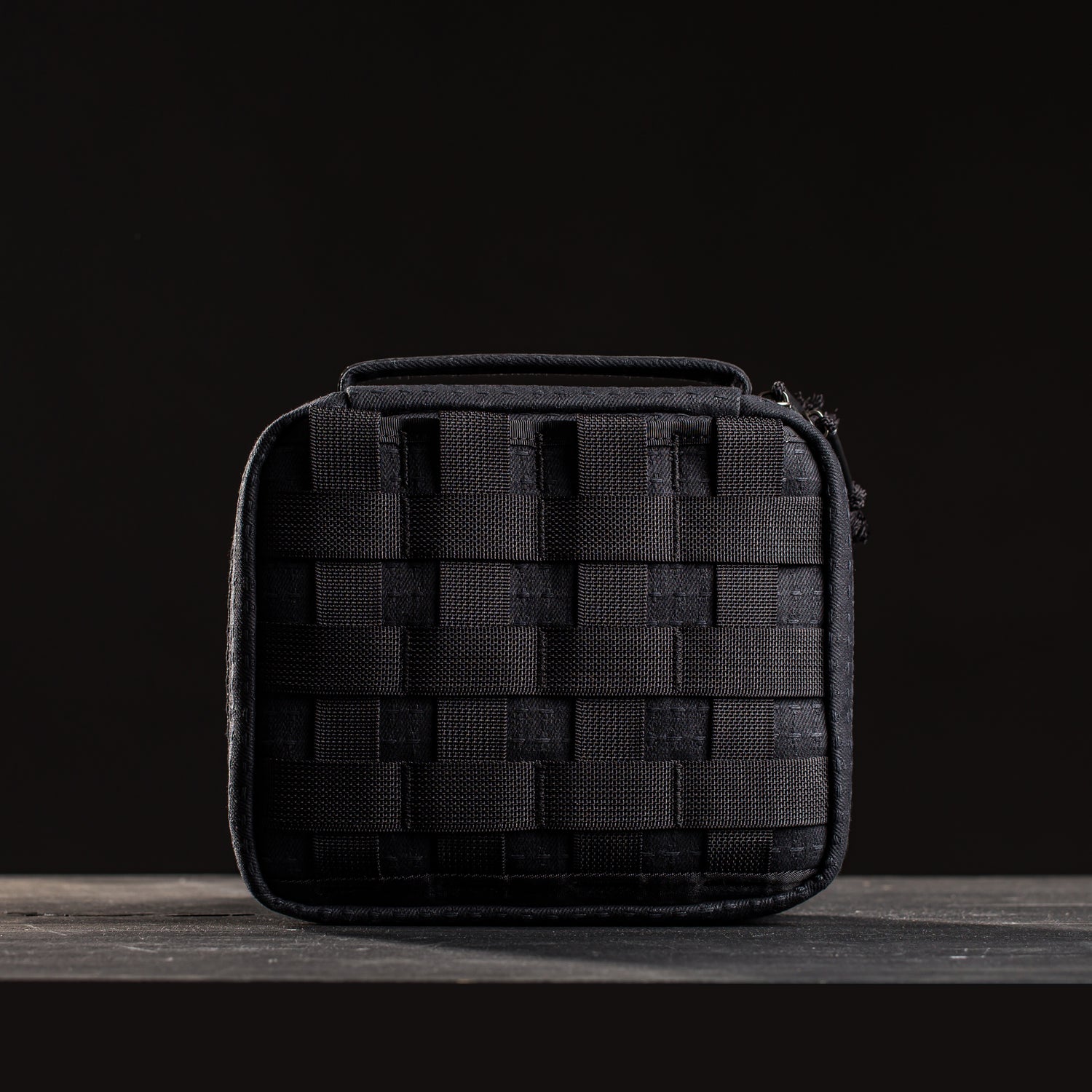 The GR2 Field Pocket - GRXC2 Samurai 2.0 is a compact black pouch with a woven pattern, made from durable JPXDP fabric, displayed on a dark surface with a black background.