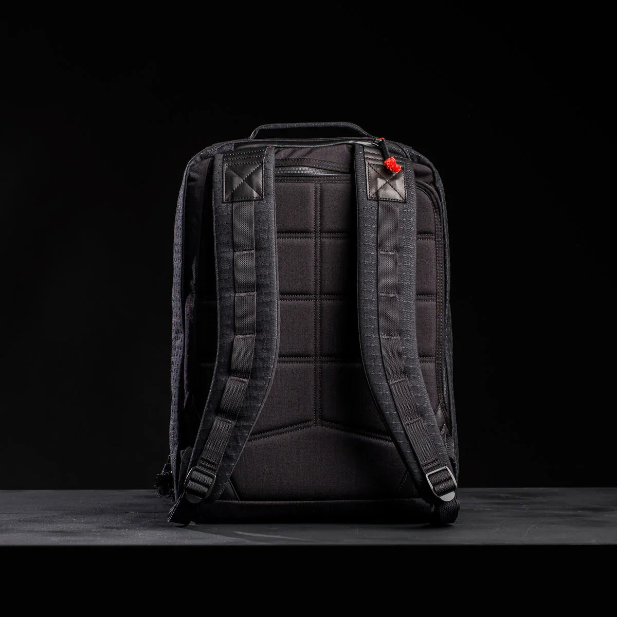 Back view of black GORUCK 26L GR2 Samuari 2.0 durable rucksack with padded straps and stitching on black surface