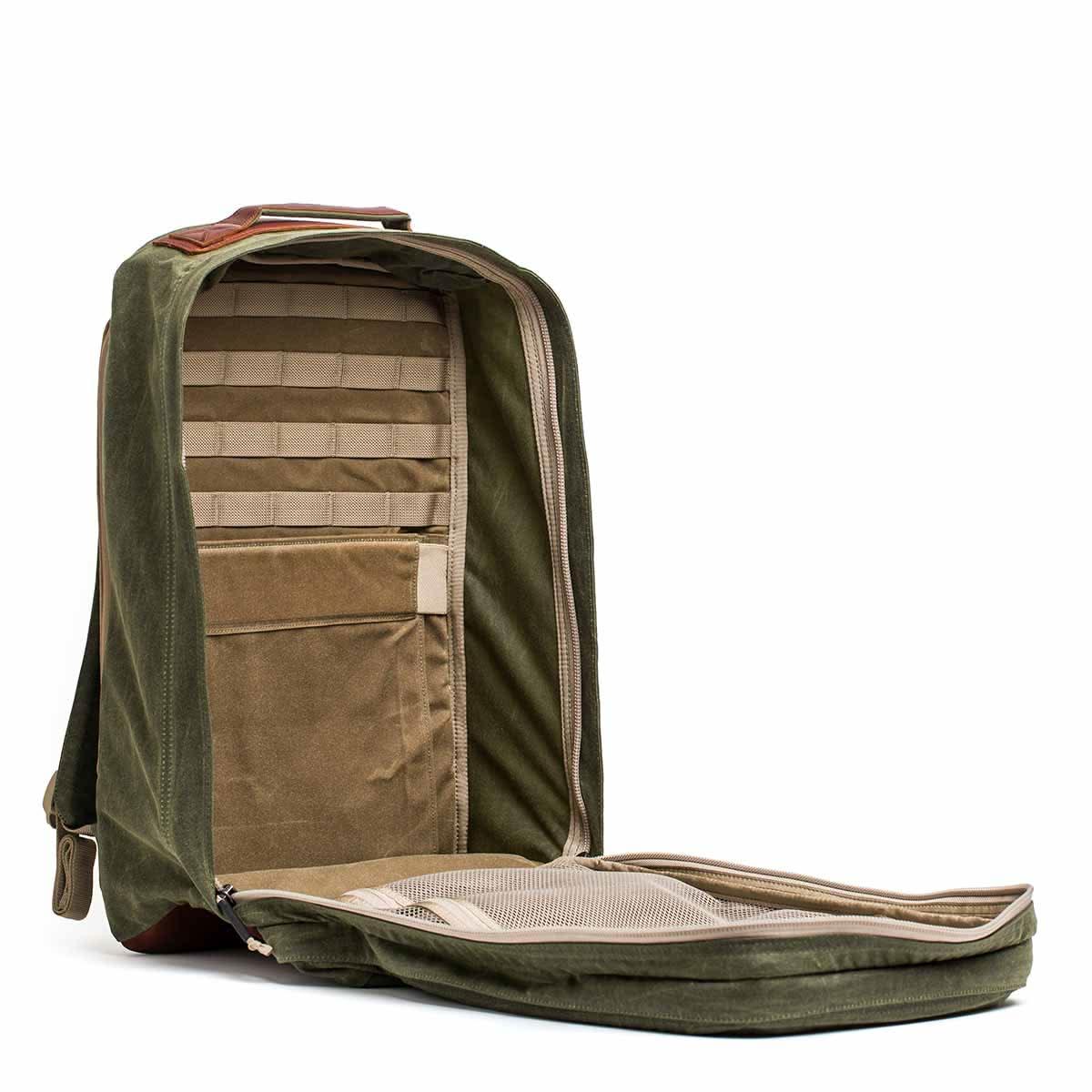 GORUCK 34L Waxed Canvas backpack in olive with tan interior open, showing organized compartments and pockets