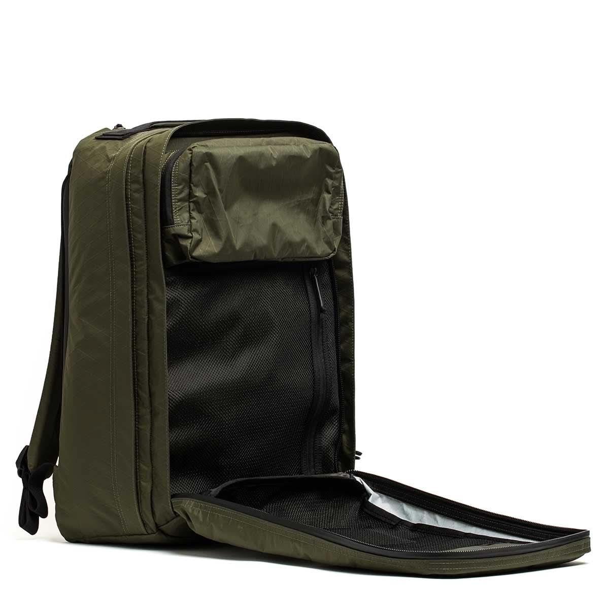 GORUCK GR2 34L rucksack in dark green with open front panel showing mesh stash pocket and organized compartments