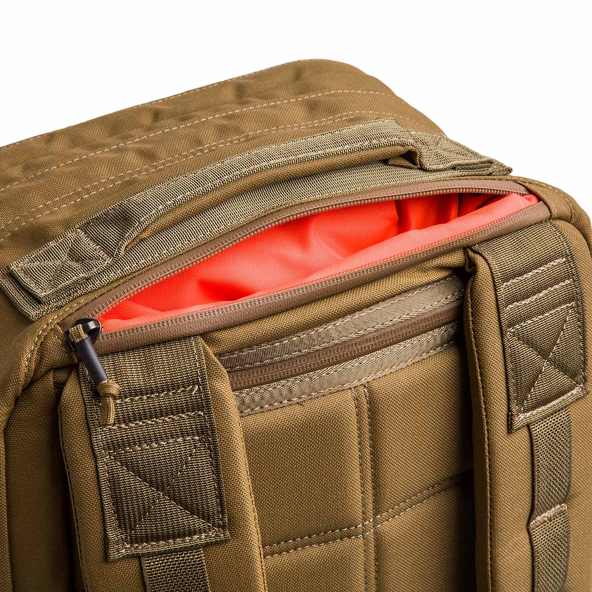Close-up of the GR2 USA - Cordura tan travel backpack with padded straps and a partially open, red-lined zipper pocket—designed for convenient carry-on rucksack use.