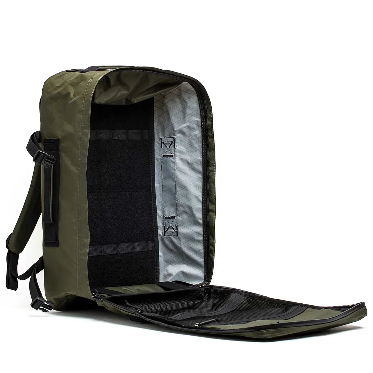 Open GORUCK dark green rucksack showing spacious interior with black and silver lining, padded shoulder straps