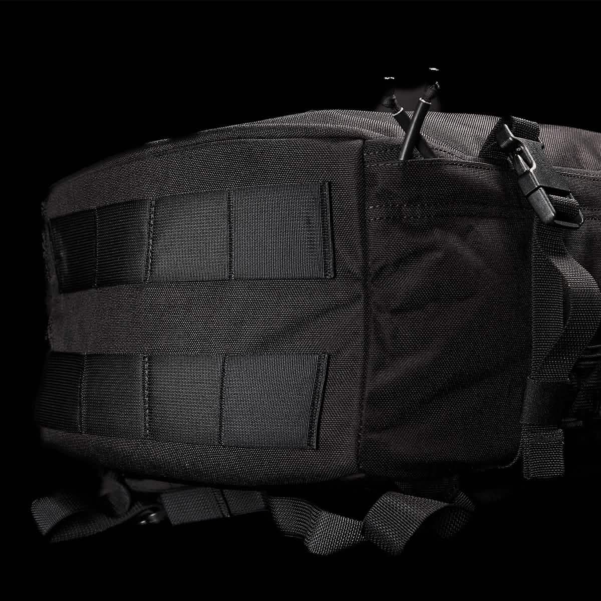 Close-up of a black GORUCK GR3 - Cordura tactical backpack against a dark background. The image highlights the rugged, water-resistant material and multiple straps, showcasing its durability and functional design as an ideal carry-on rucksack.